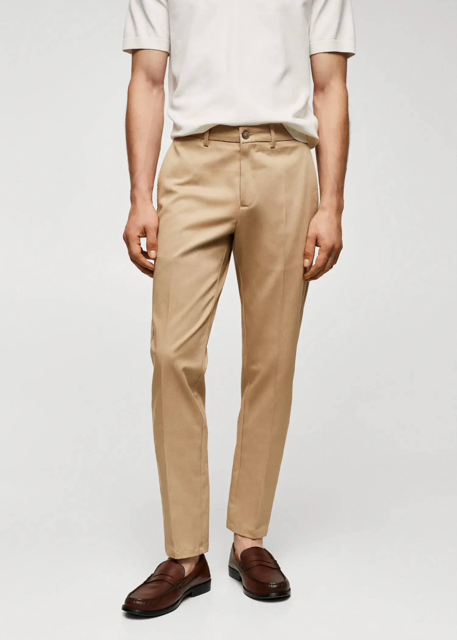 Mango Slim fit chino trousers. a man wearing a white shirt and tan pants. 