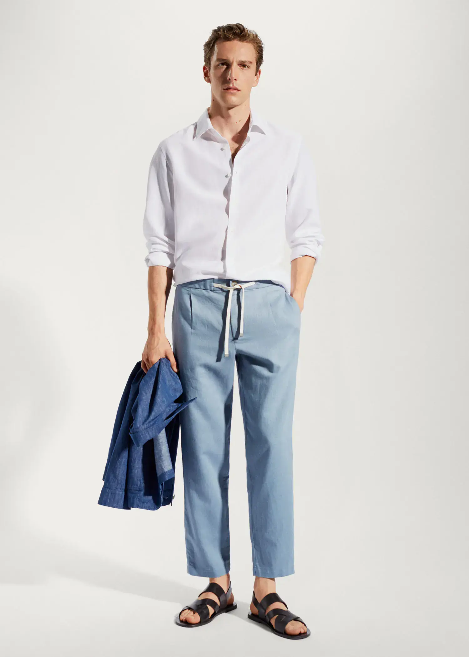 Mango Slim-fit pants with drawstring . a man wearing a white shirt and blue pants. 