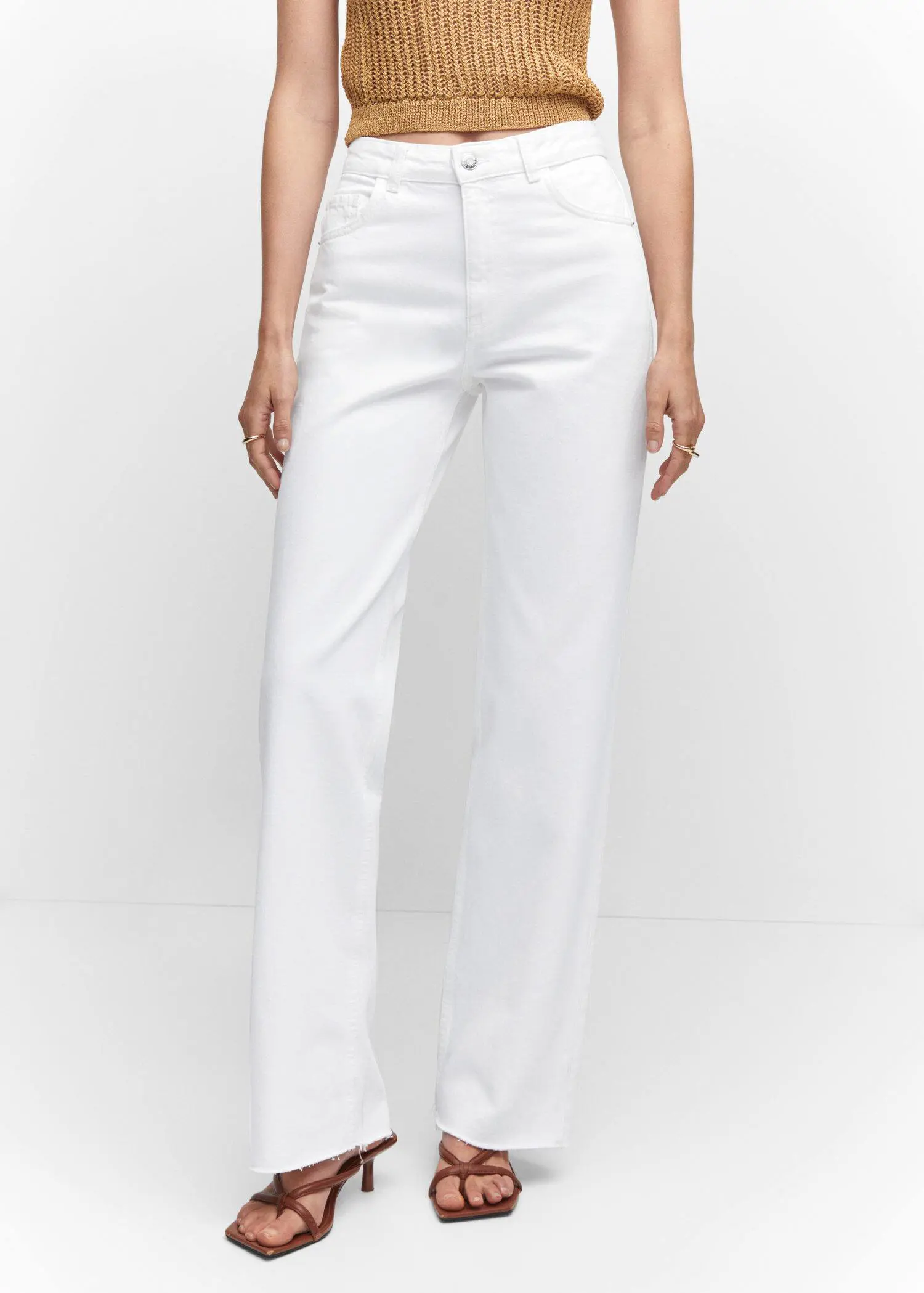 Mango Wideleg mid-rise jeans. a woman wearing white pants and a white top. 
