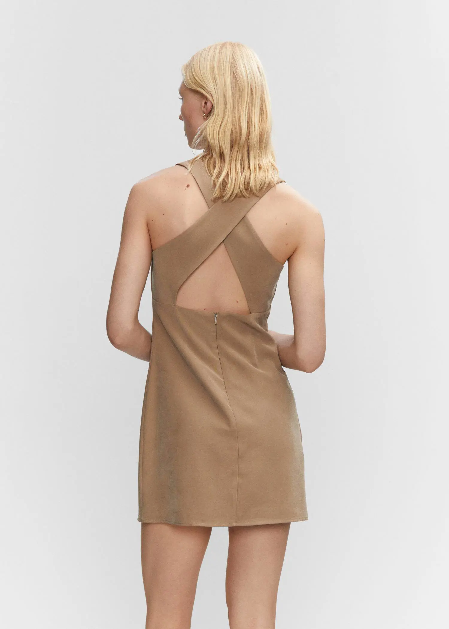 Mango Wrap back dress. a woman in a tan dress is standing up. 