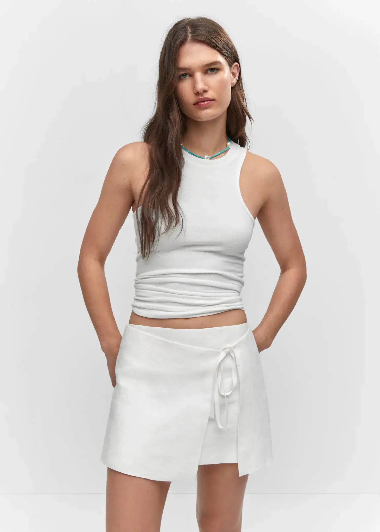 Mango Linen-blend wrap skirt. a woman in a white outfit posing for a picture. 