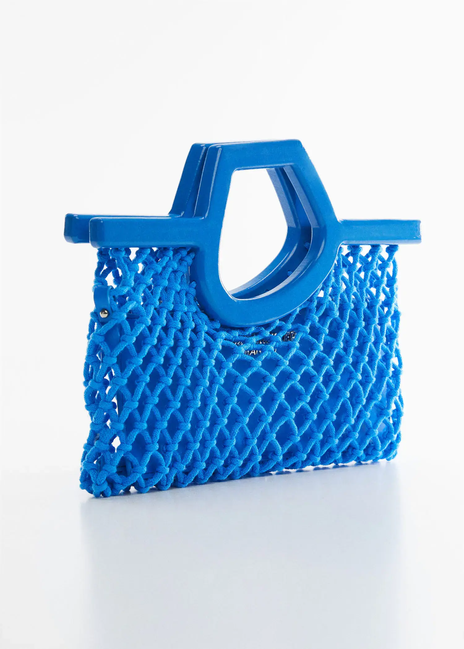 Mango Mesh bag with irregular handle. a blue bag is sitting on a table. 