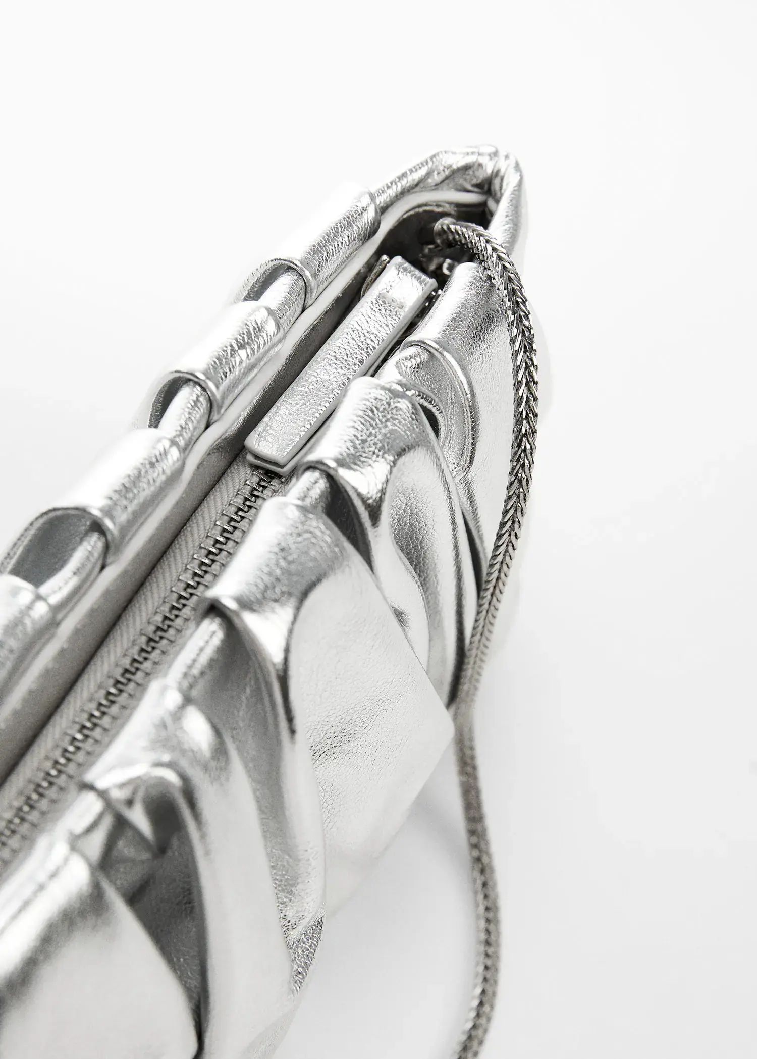 Mango Quilted chain bag. a close-up view of a silver purse. 