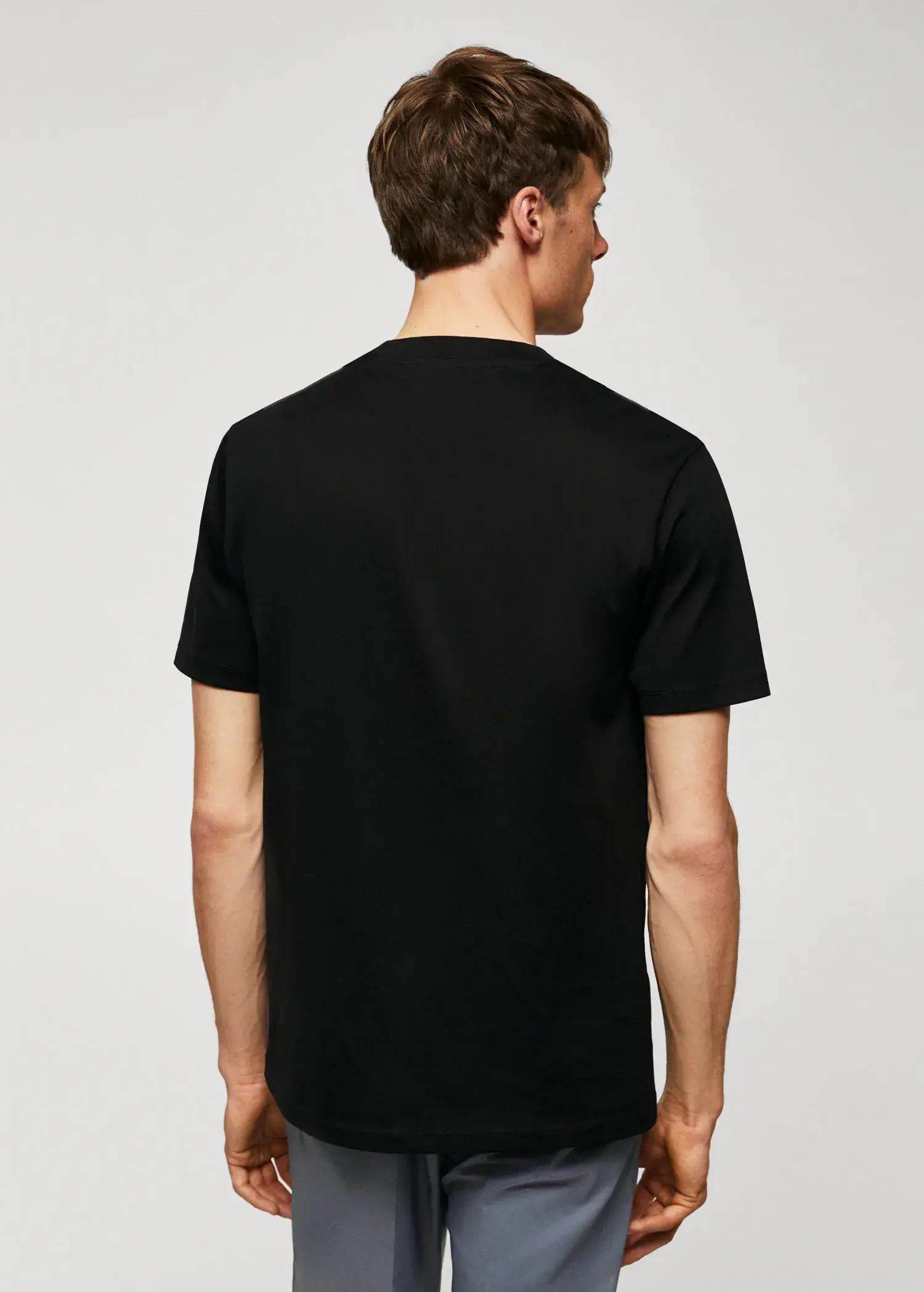Mango Mercerised regular-fit t-shirt. a man in a black shirt is looking back. 