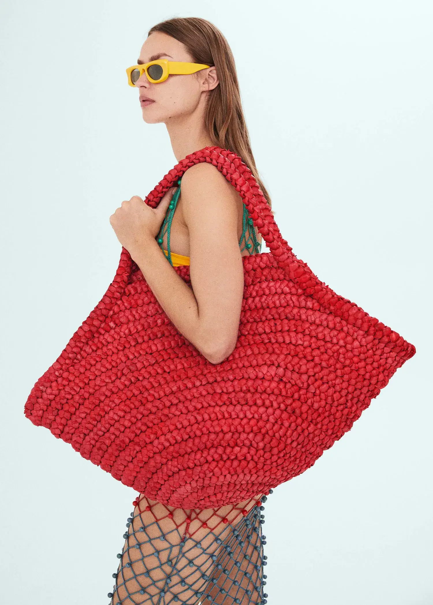 Mango Natural fibre maxi tote bag. a woman holding a red bag in her hands. 
