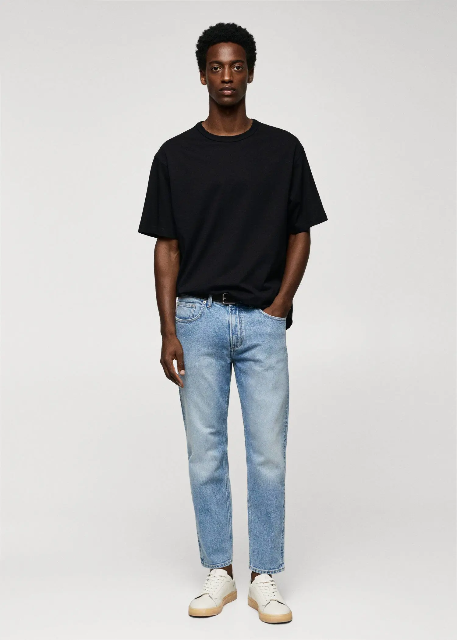 Mango Ben tapered cropped jeans. a man wearing a black shirt and jeans. 