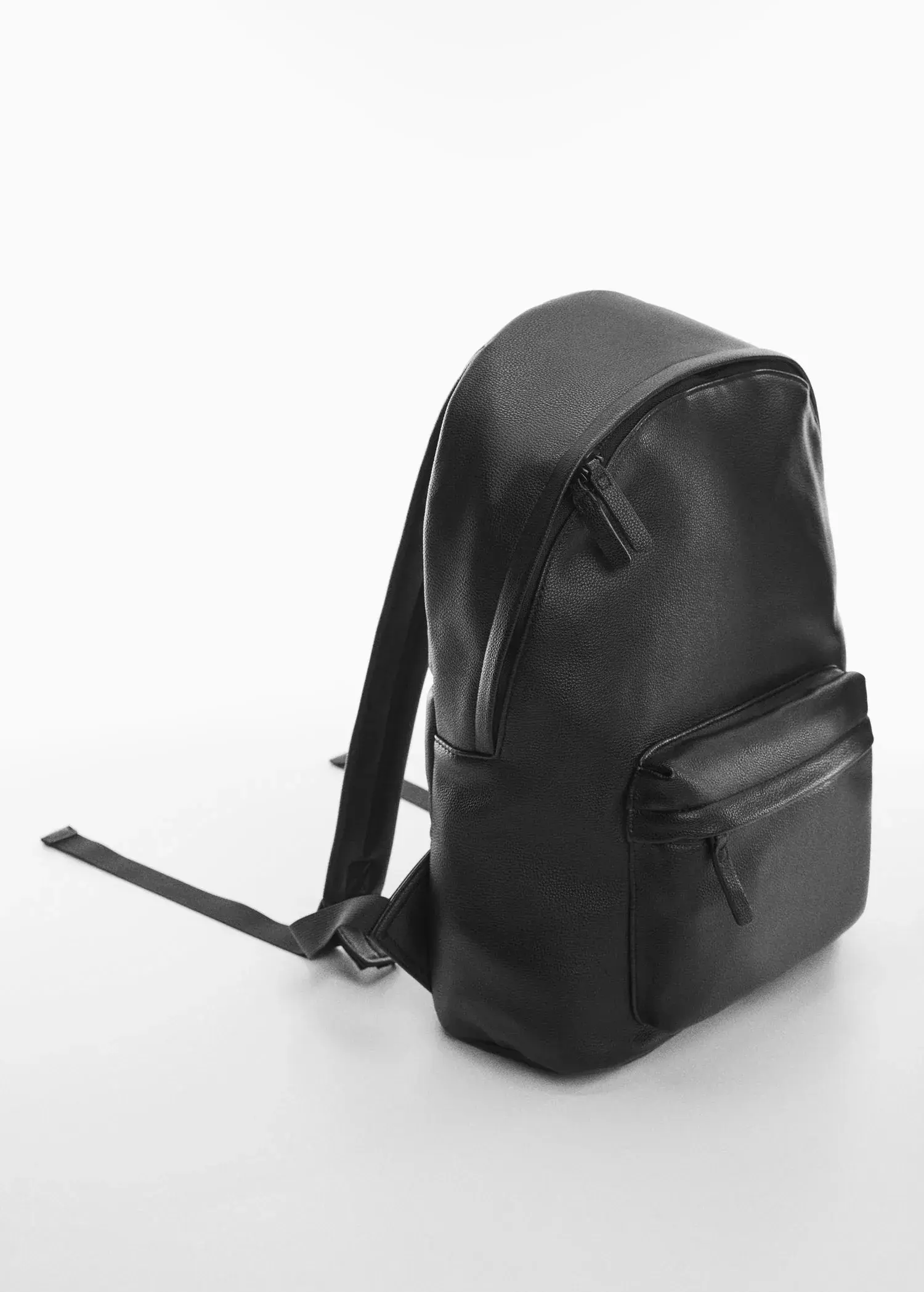 Mango Leather-effect backpack. a black leather backpack sitting on top of a table. 