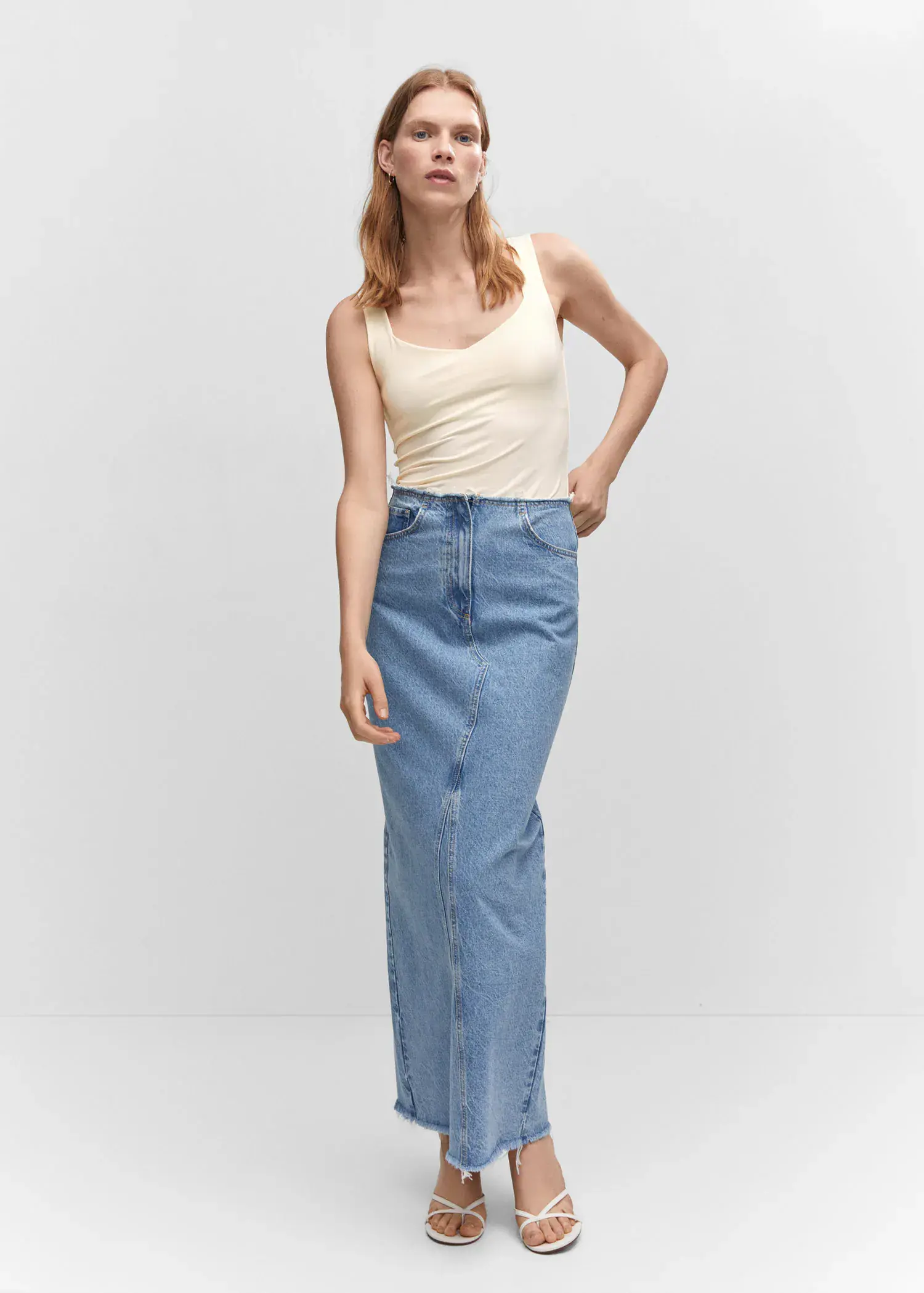 Mango Open elastic top. a woman standing in front of a white wall. 