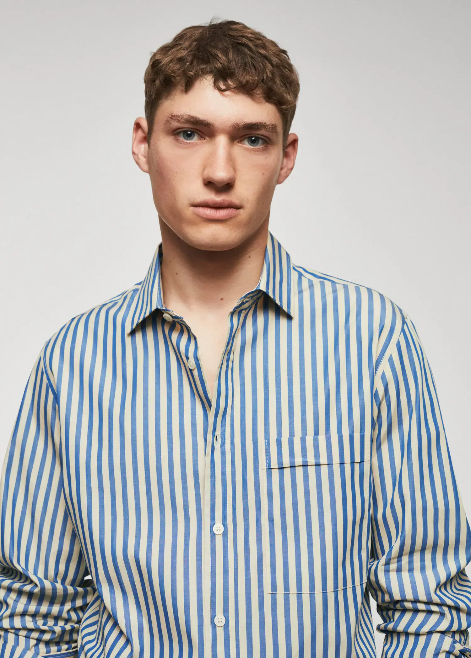 Mango 100% cotton Kodak striped shirt . a young man wearing a striped button up shirt. 