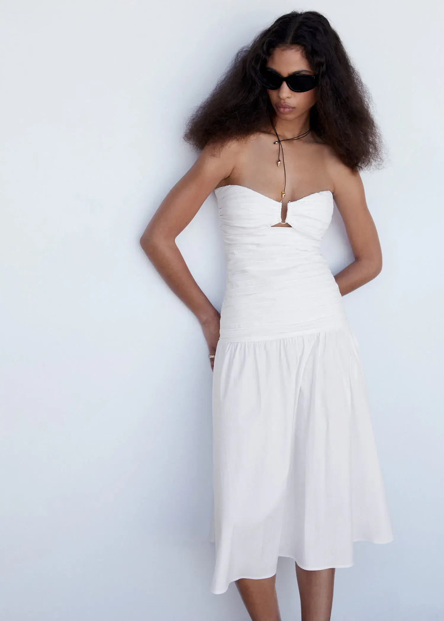 Mango Draped dress with metallic detail. a woman in a long white dress standing next to a wall. 