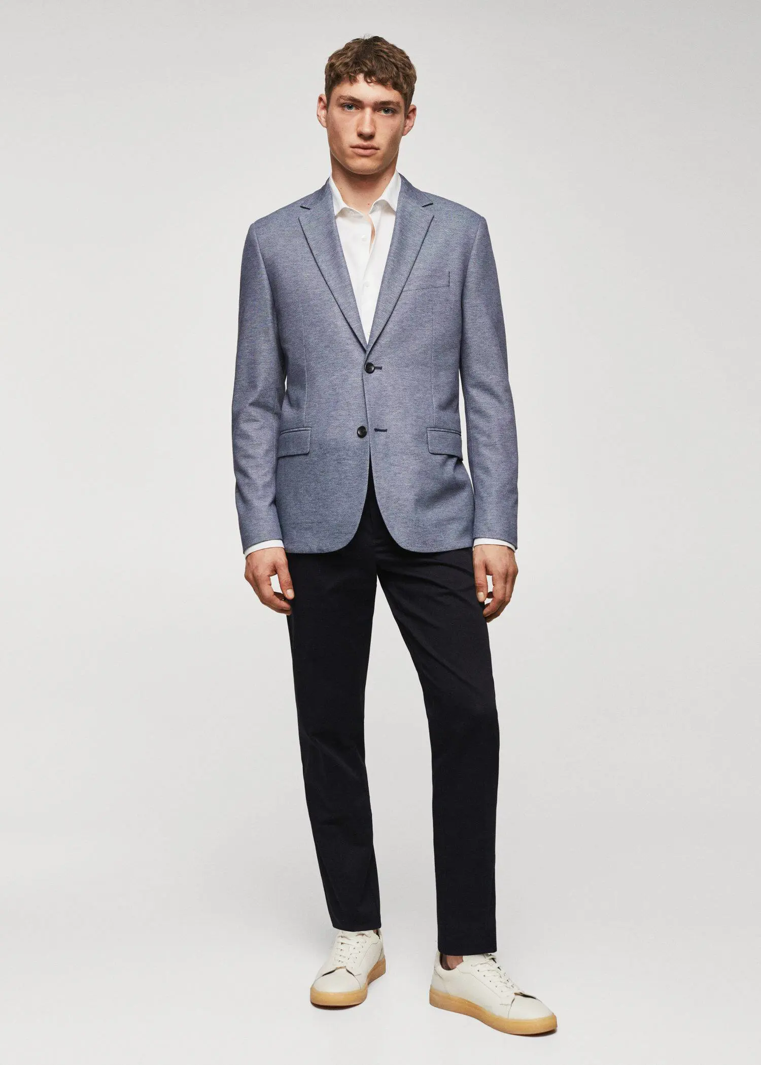 Mango Slim fit microstructure blazer. a man wearing a suit and tie standing in front of a white wall. 