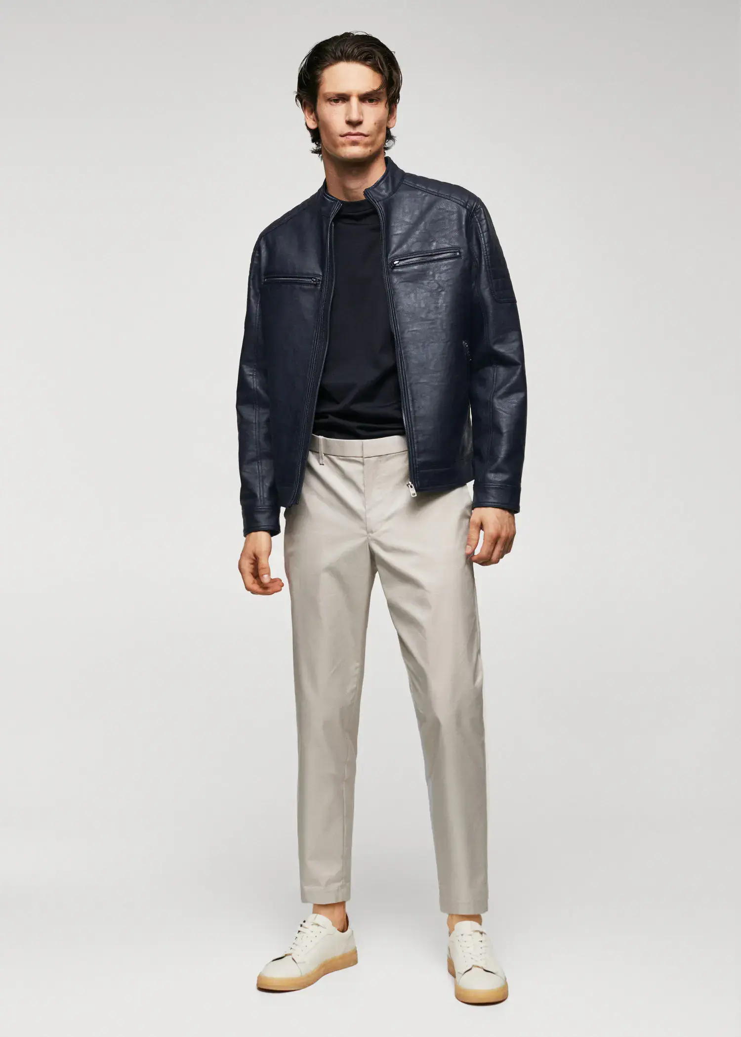Mango Nappa leather-effect jacket. a man in a black jacket and white pants. 