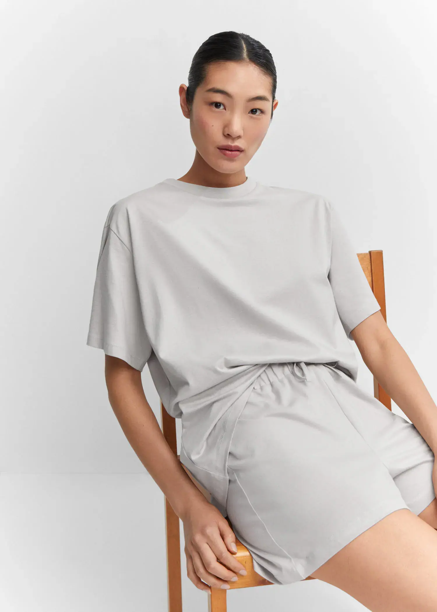 Mango Short cotton pyjamas. a person sitting on a chair wearing a white shirt. 