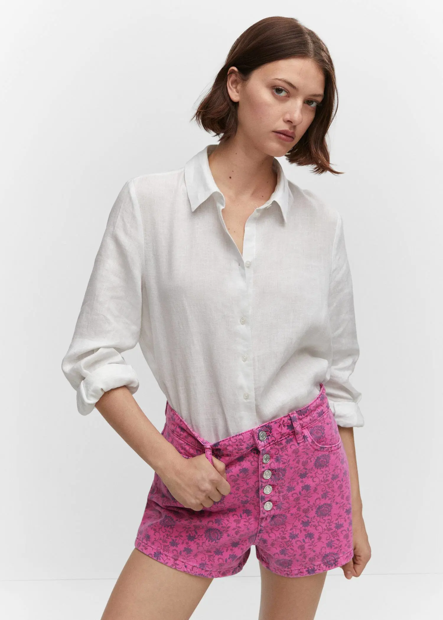 Mango Printed denim shorts. a woman wearing a white shirt and a pink skirt. 