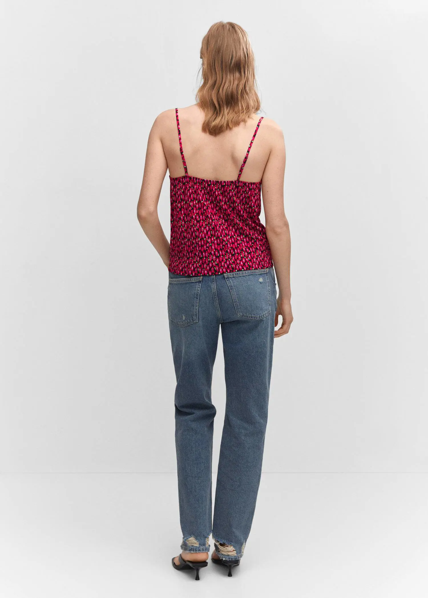 Mango Print ruched top. a woman is standing in front of the camera. 