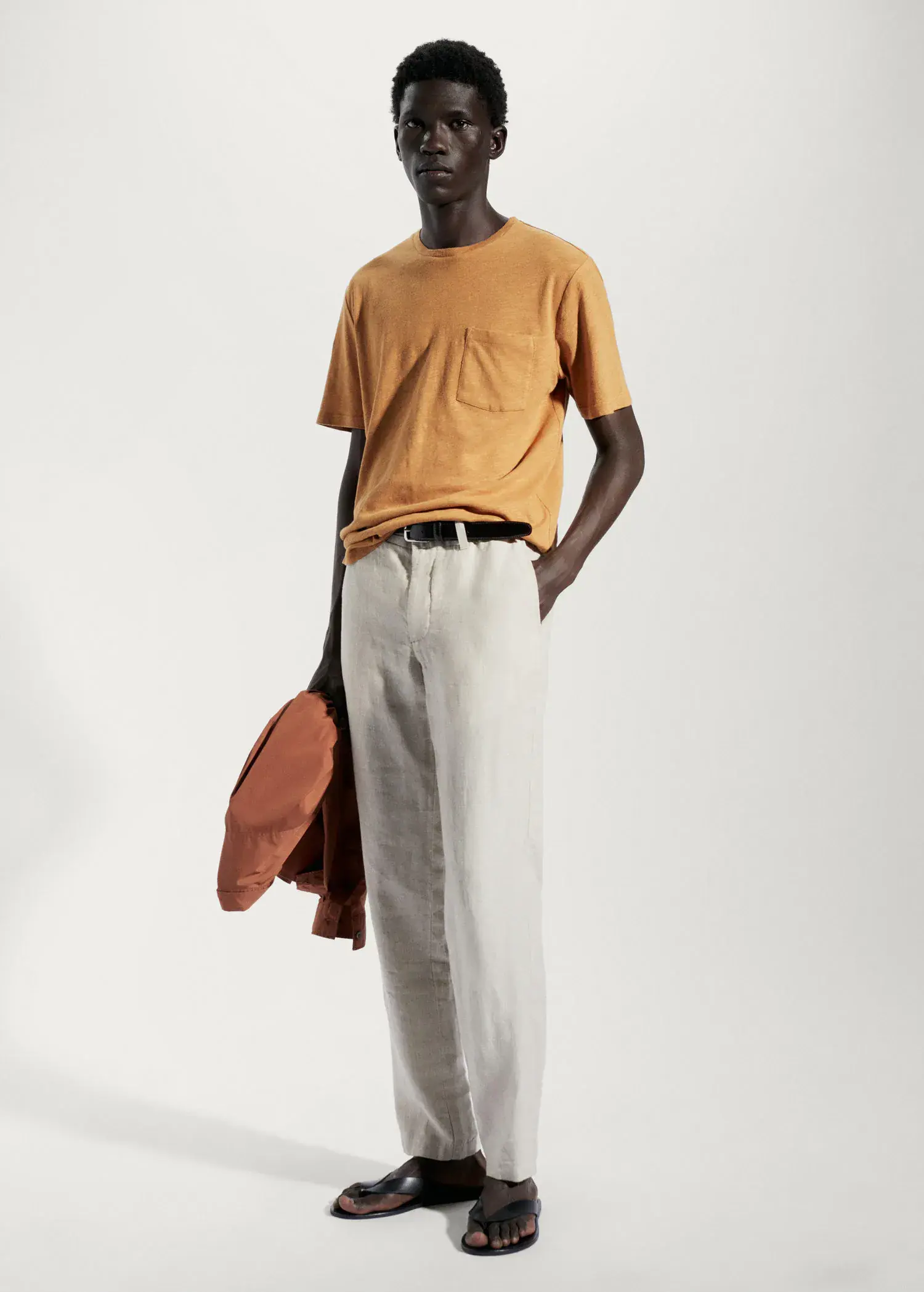 Mango Cotton-linen pocket t-shirt. a man in a yellow shirt and white pants. 