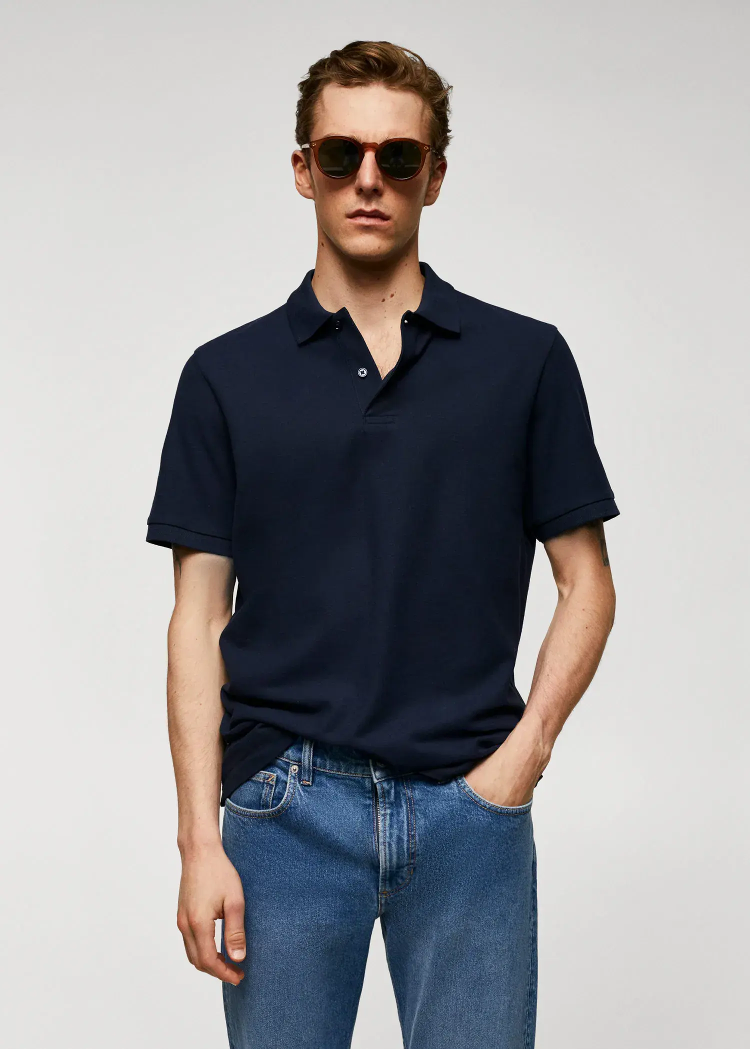 Mango 100% cotton pique polo shirt. a man in a black shirt and sunglasses. 