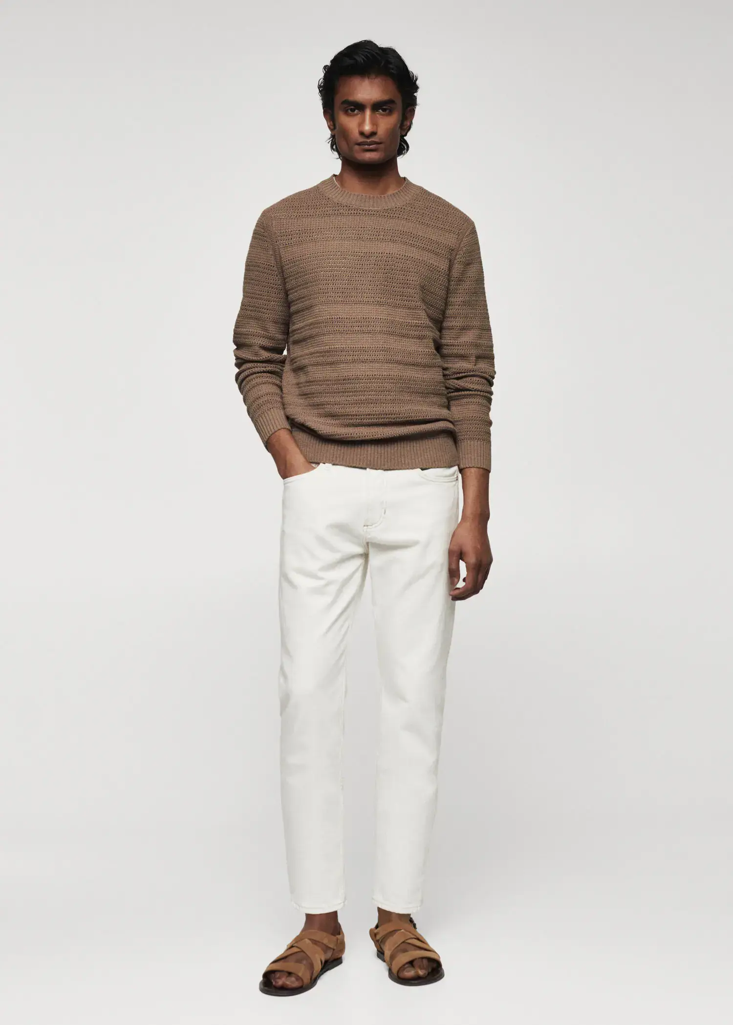 Mango Openwork cotton sweater. a man wearing a brown sweater and white pants. 