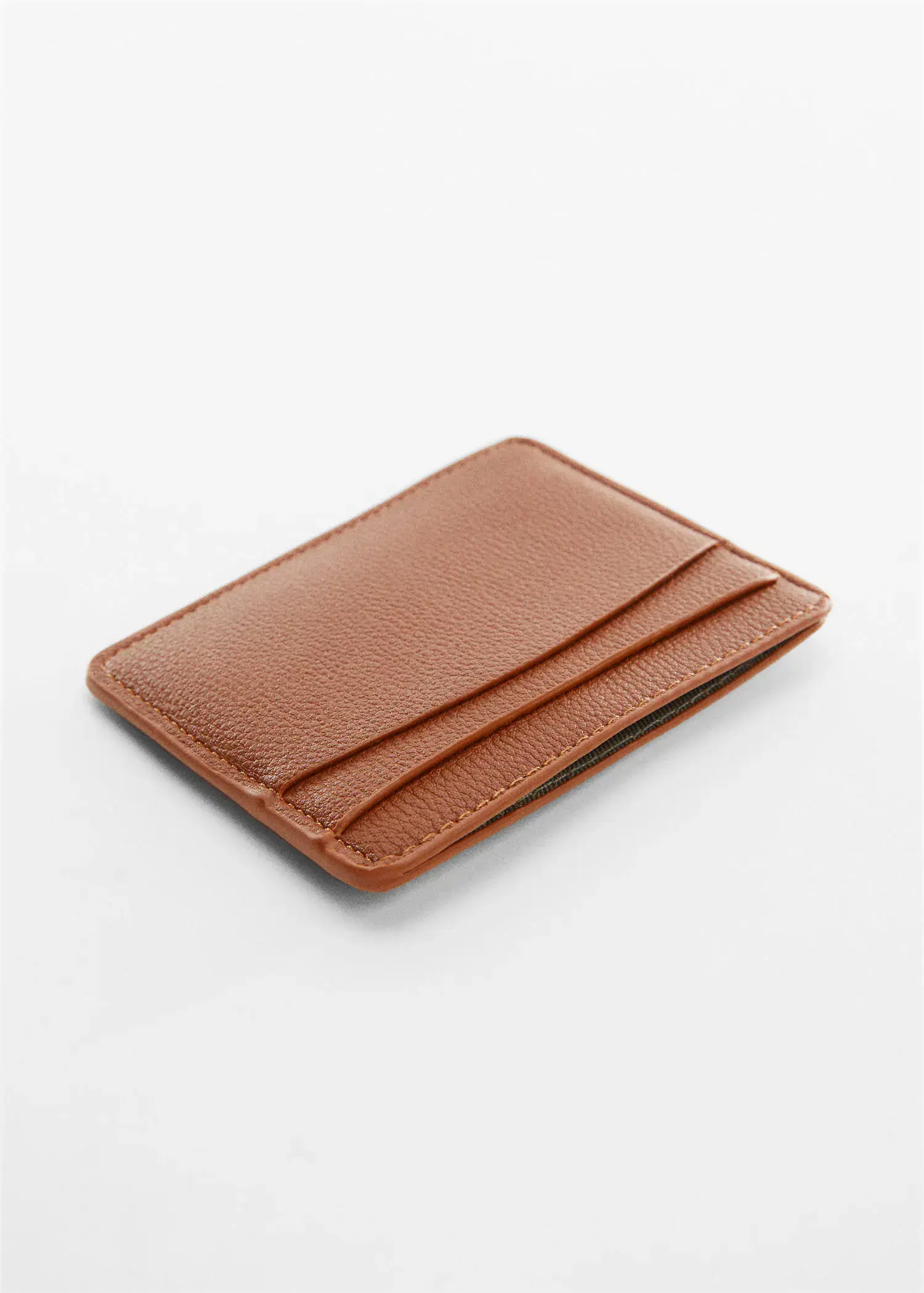 Mango Anti-contactless leather-effect card holder. a brown wallet is sitting on top of a table. 
