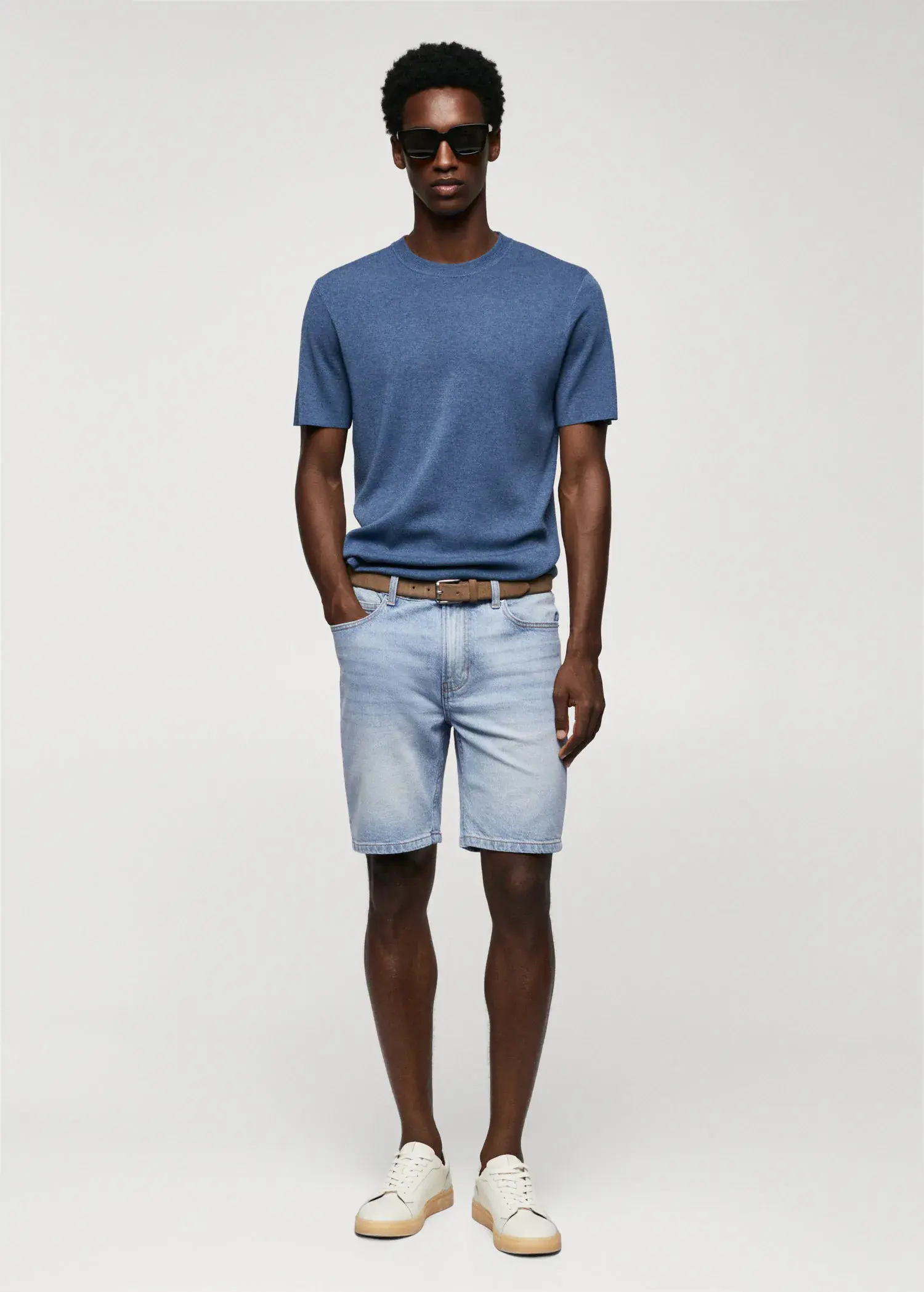 Mango Regular-fit denim bermuda shorts. a man in blue shirt and shorts standing with his hands in his pockets. 