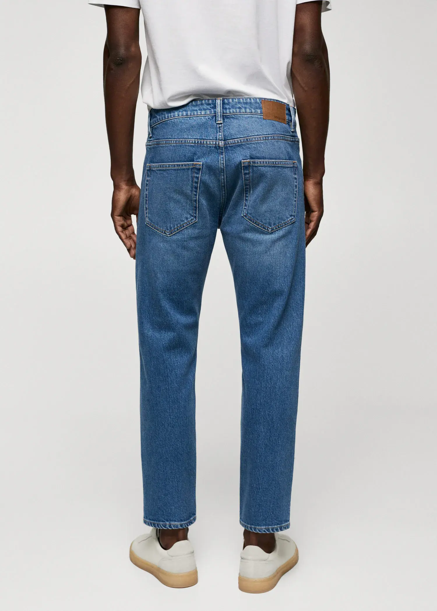 Mango Ben tapered cropped jeans. a person wearing a pair of blue jeans. 