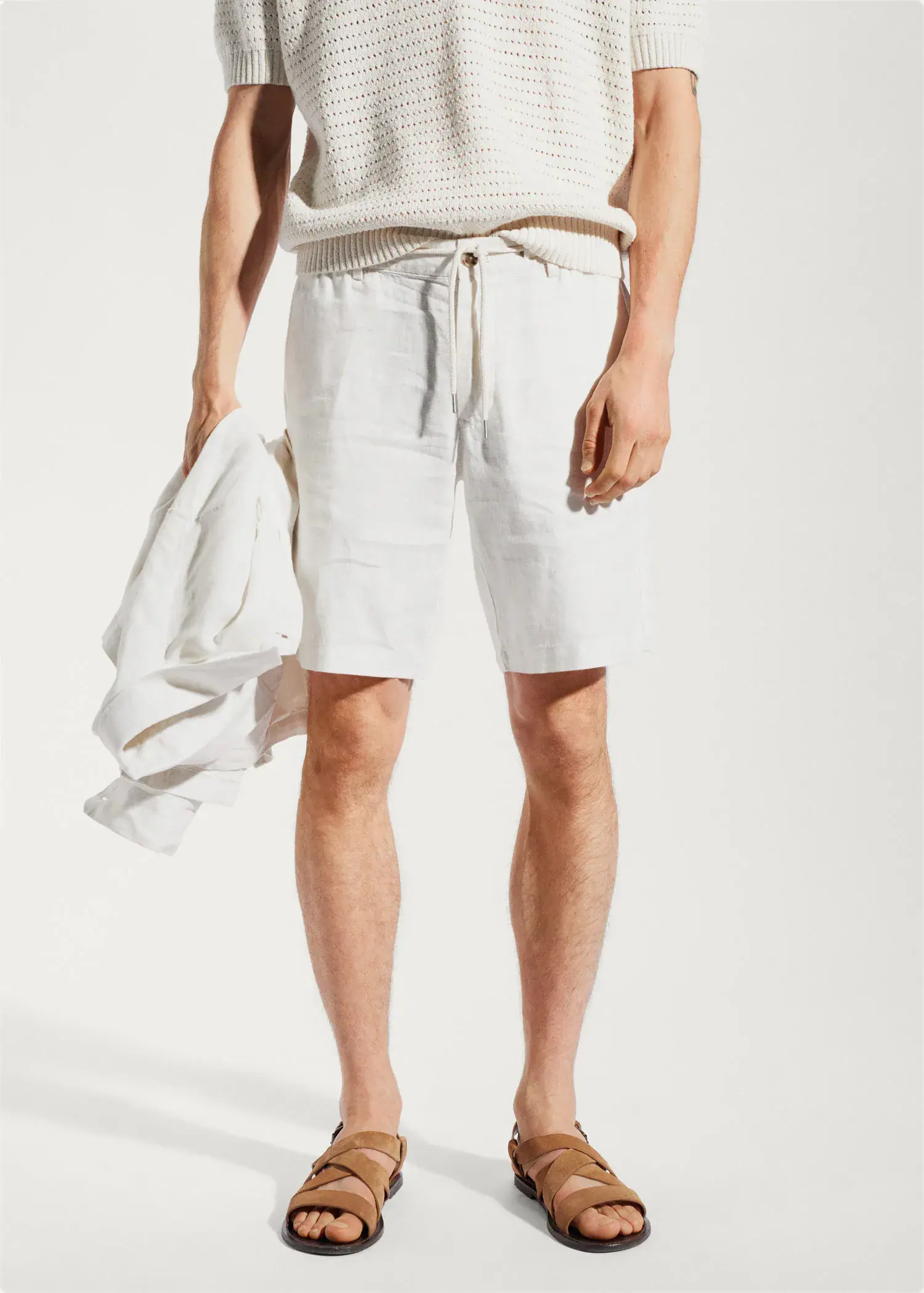 Mango 100% linen bermuda shorts with drawstring. a man in white shorts holding a white towel. 