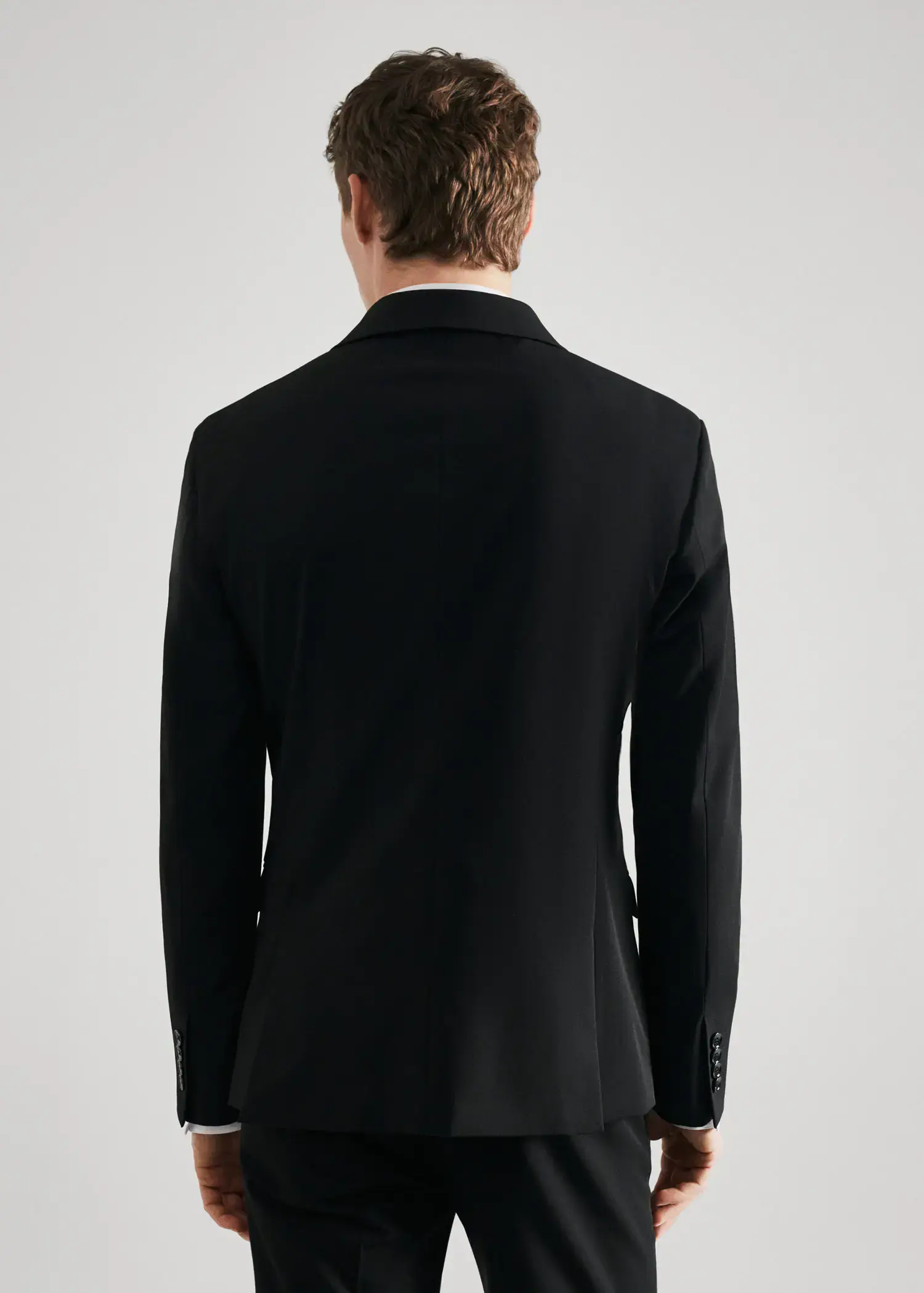 Mango Super slim-fit suit blazer in stretch fabric. a man wearing a black suit jacket. 