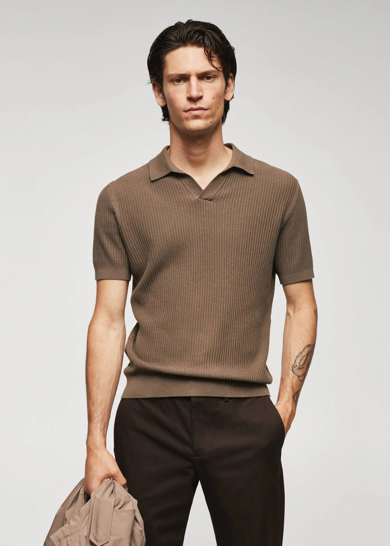 Mango Ribbed cotton polo shirt. a man in a brown shirt is posing for a picture 