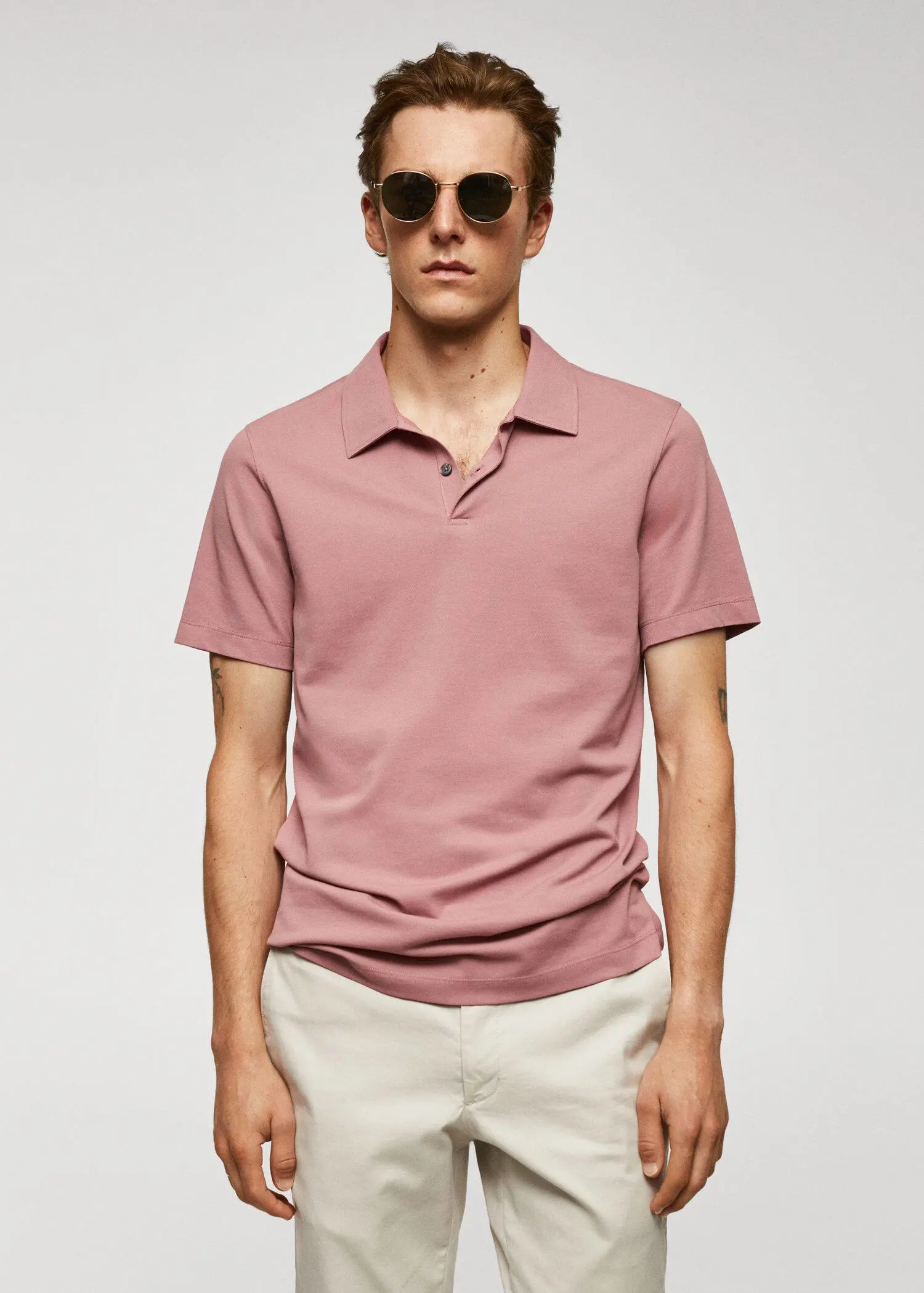 Mango Slim-fit textured cotton polo shirt. a man in a pink polo shirt and white pants. 