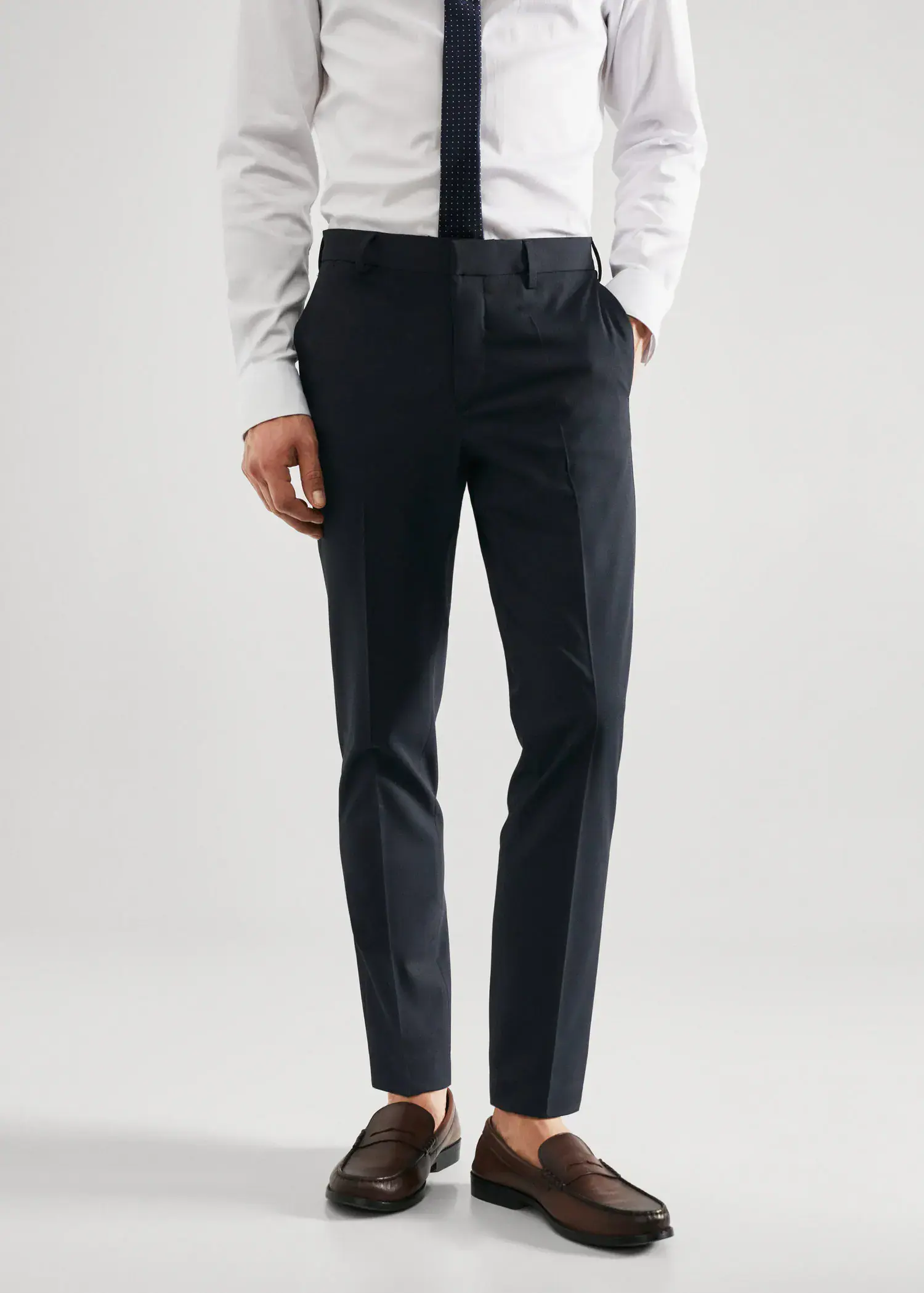 Mango Super slim fit suit trousers. a man wearing a white dress shirt and black pants. 