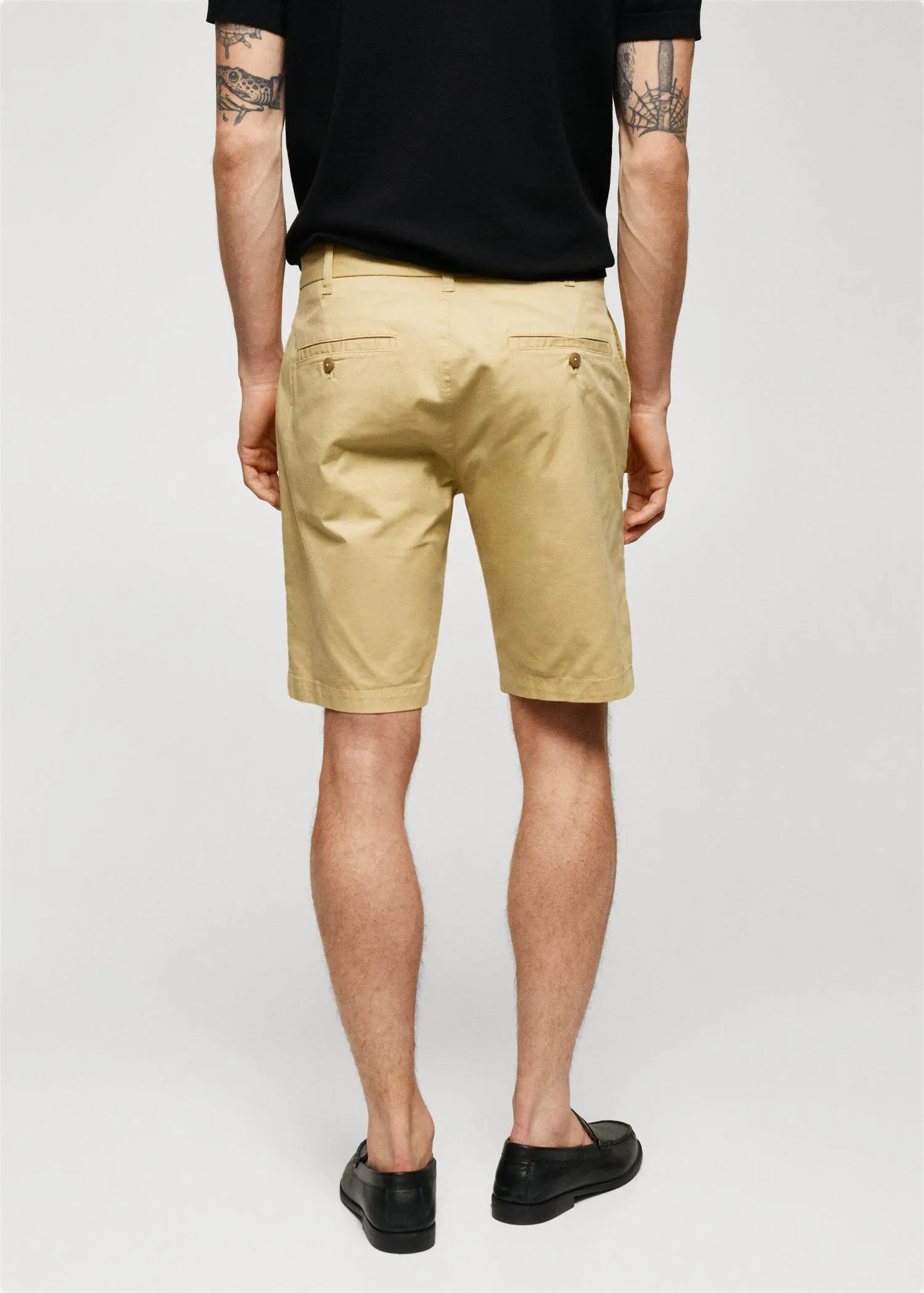 Mango Chino Bermuda shorts. a man wearing a pair of khaki shorts. 