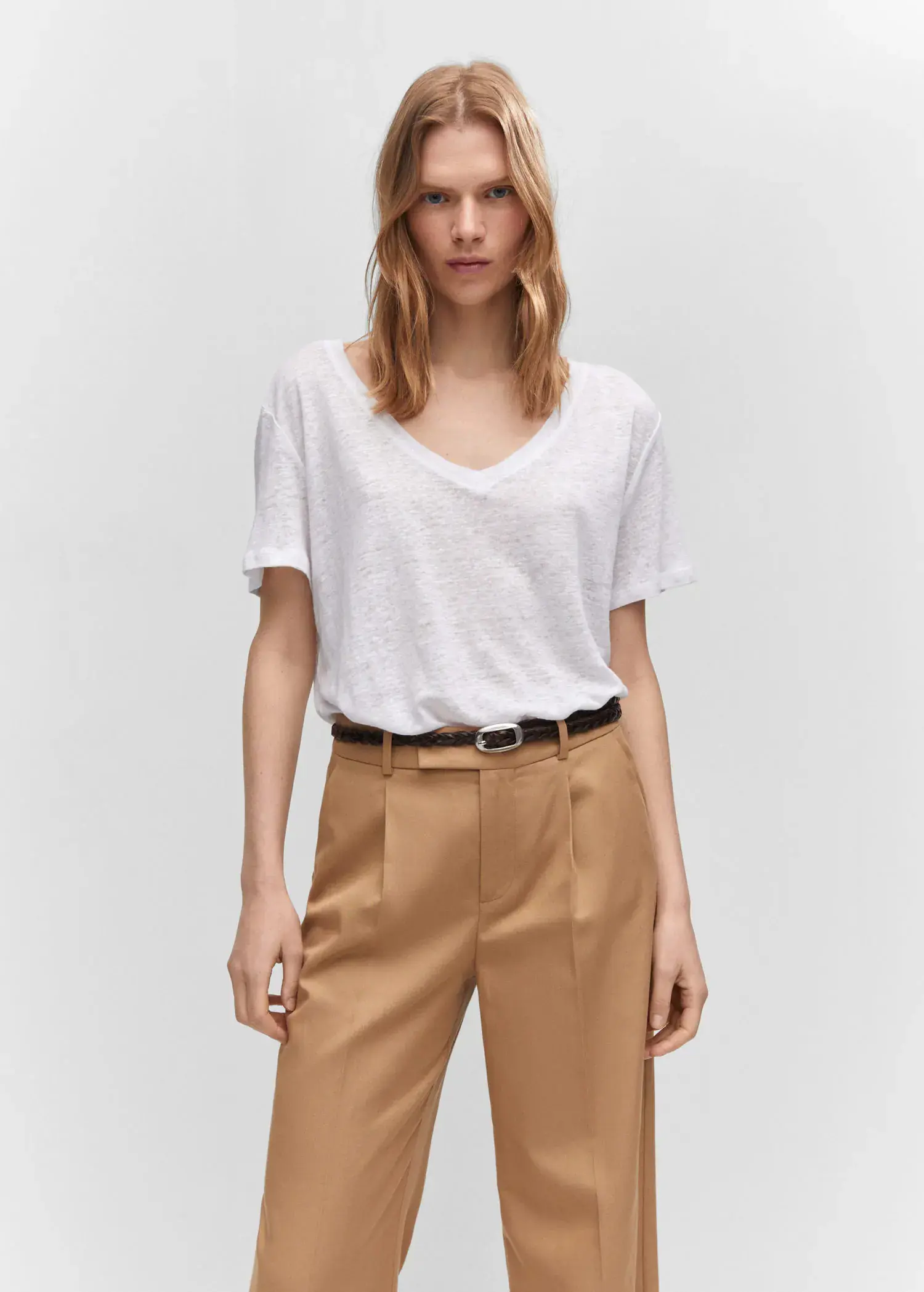 Mango V-neck linen t-shirt. a woman wearing a white shirt and brown pants. 