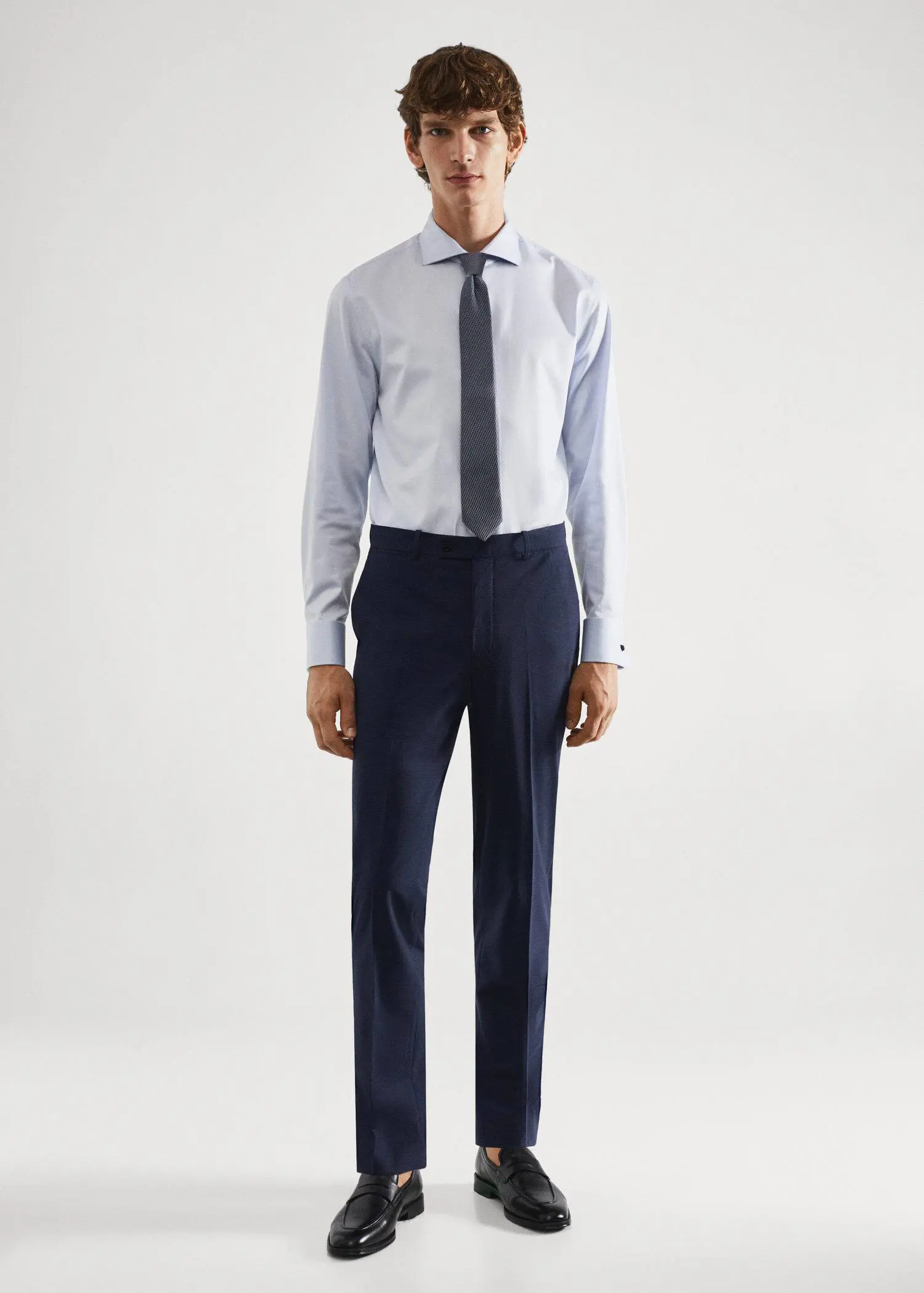 Mango Wool slim-fit check suit trousers. a man in a suit and tie standing in front of a white wall. 