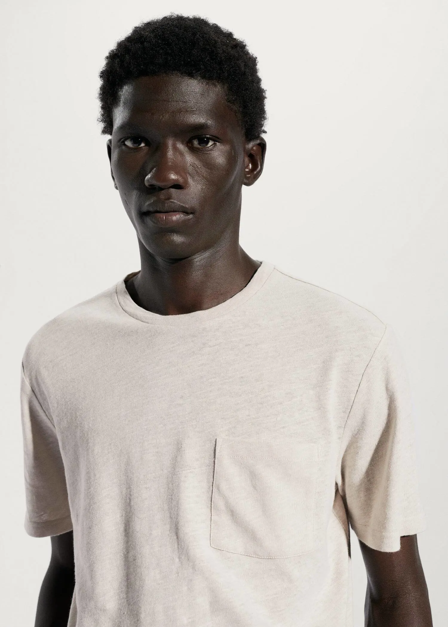 Mango Cotton-linen pocket t-shirt. a young man with dark skin wearing a t-shirt. 