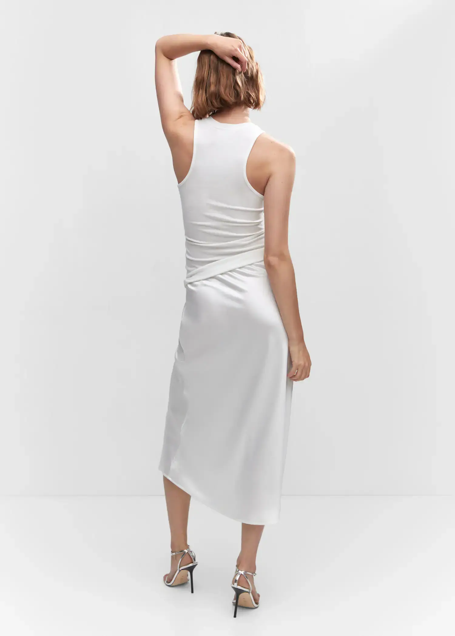 Mango Ribbed strap top. a woman wearing a white dress standing in a room. 