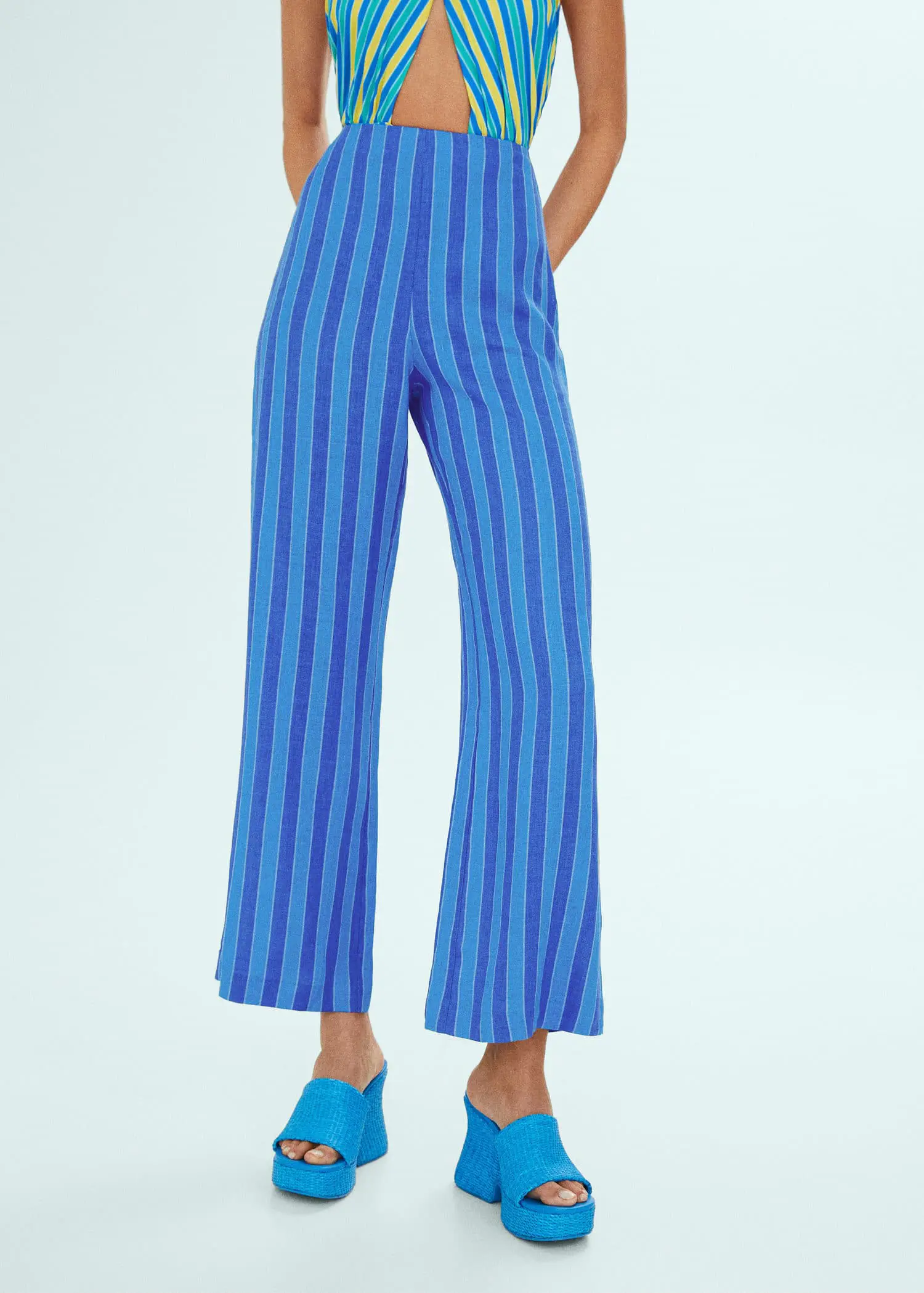 Mango Striped linen-blend trousers. a person wearing blue pants and blue shoes. 