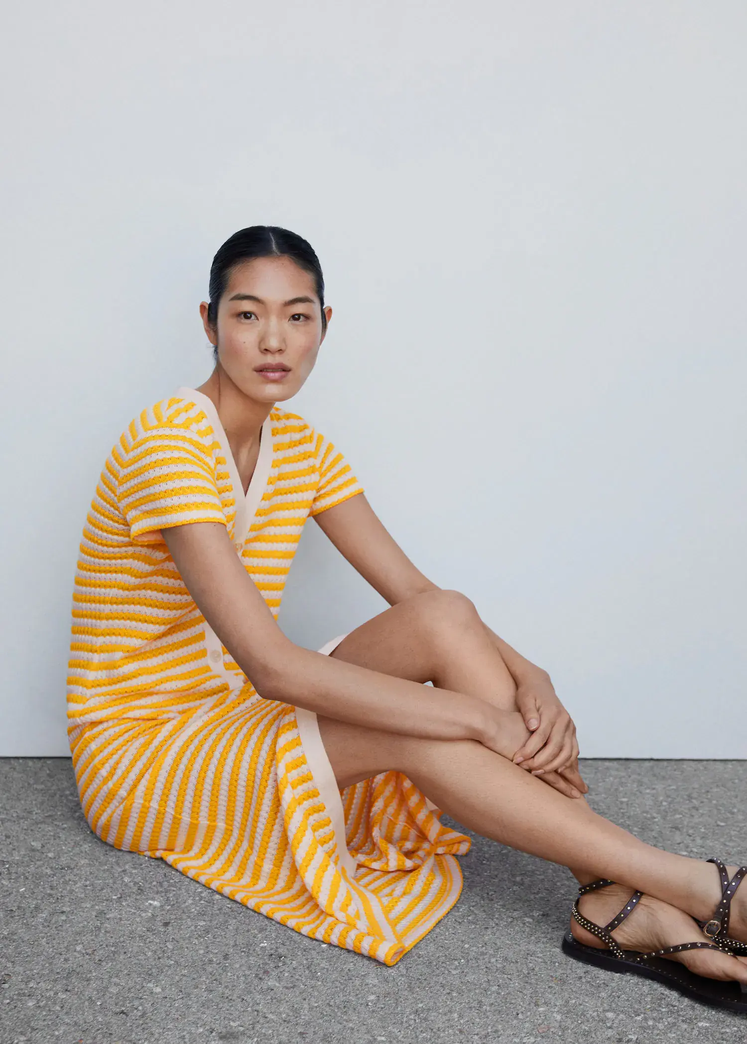 Mango Striped jersey dress. a woman sitting on the ground wearing a dress. 