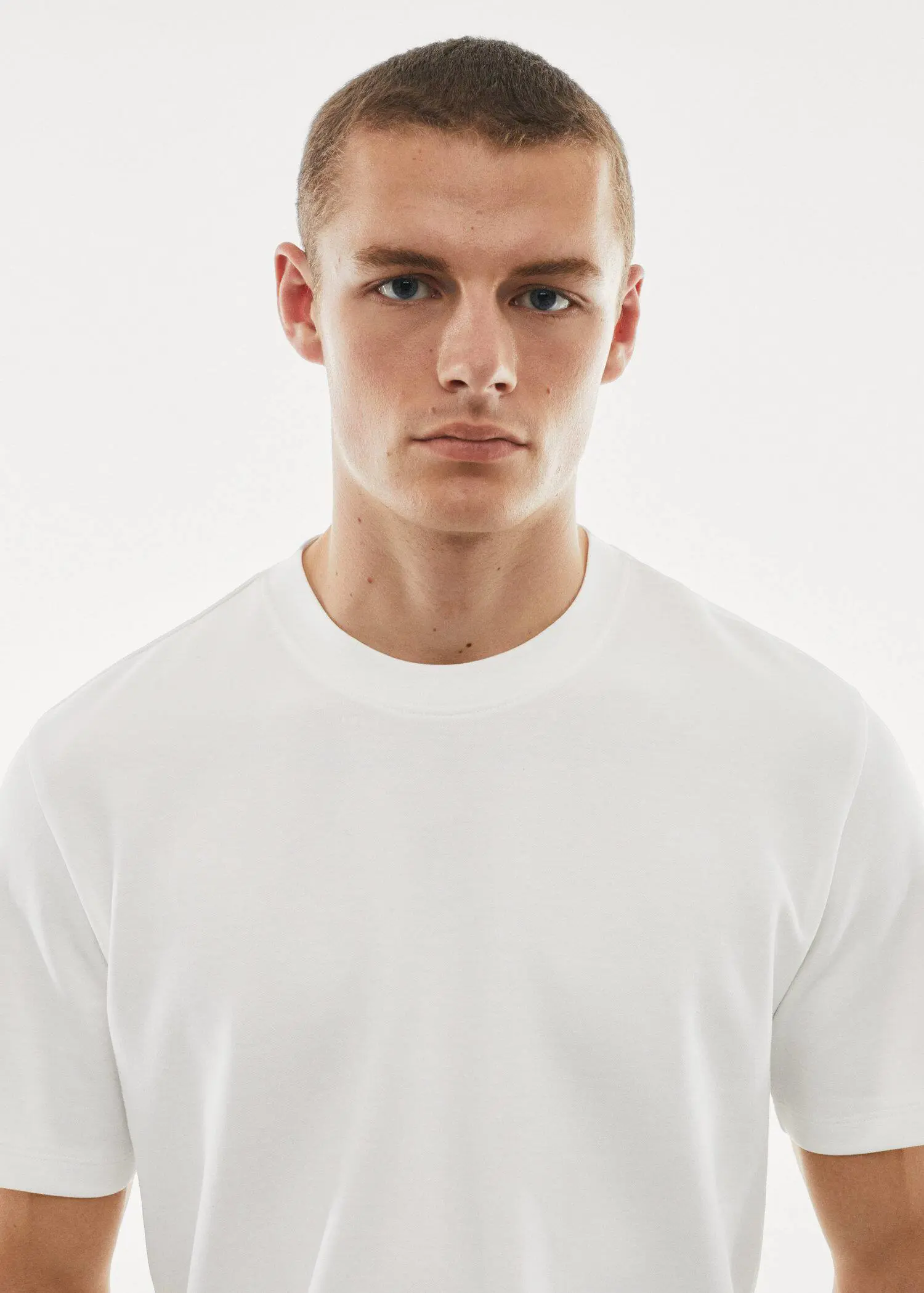 Mango Breathable cotton t-shirt. a young man wearing a white t-shirt. 