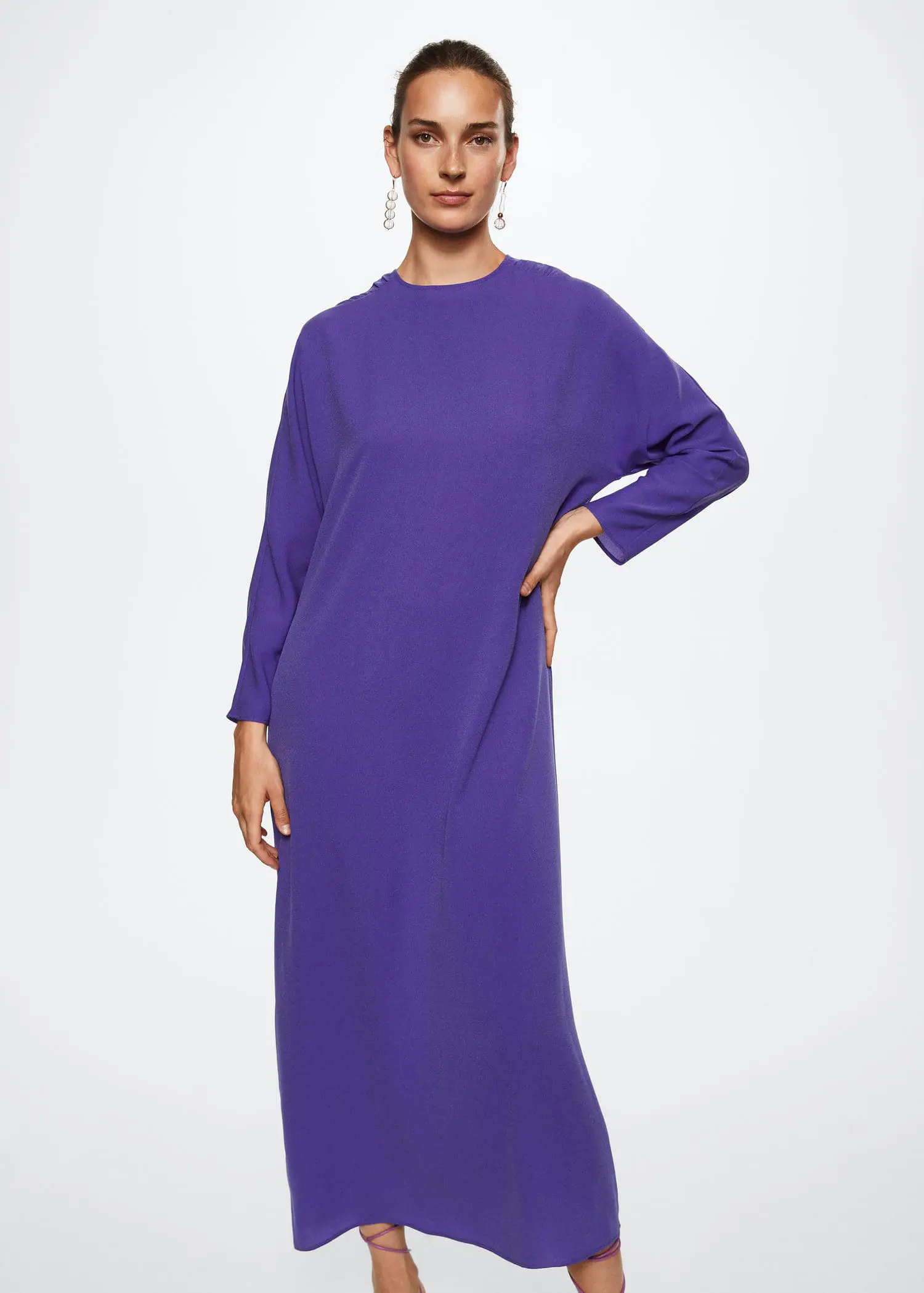 Mango Ruched detail dress. a woman wearing a purple dress standing in front of a white wall. 