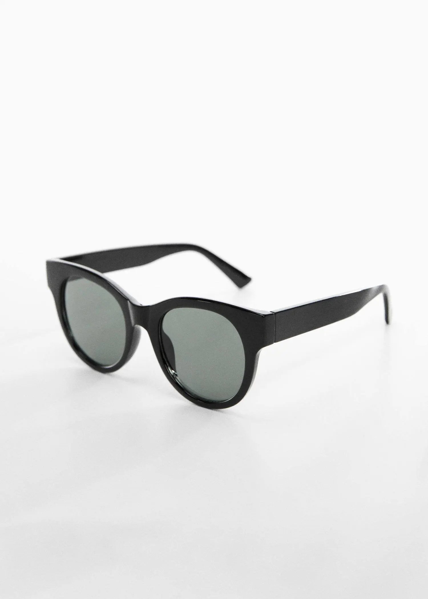 Mango Tortoiseshell sunglasses. a pair of sunglasses on a white surface. 
