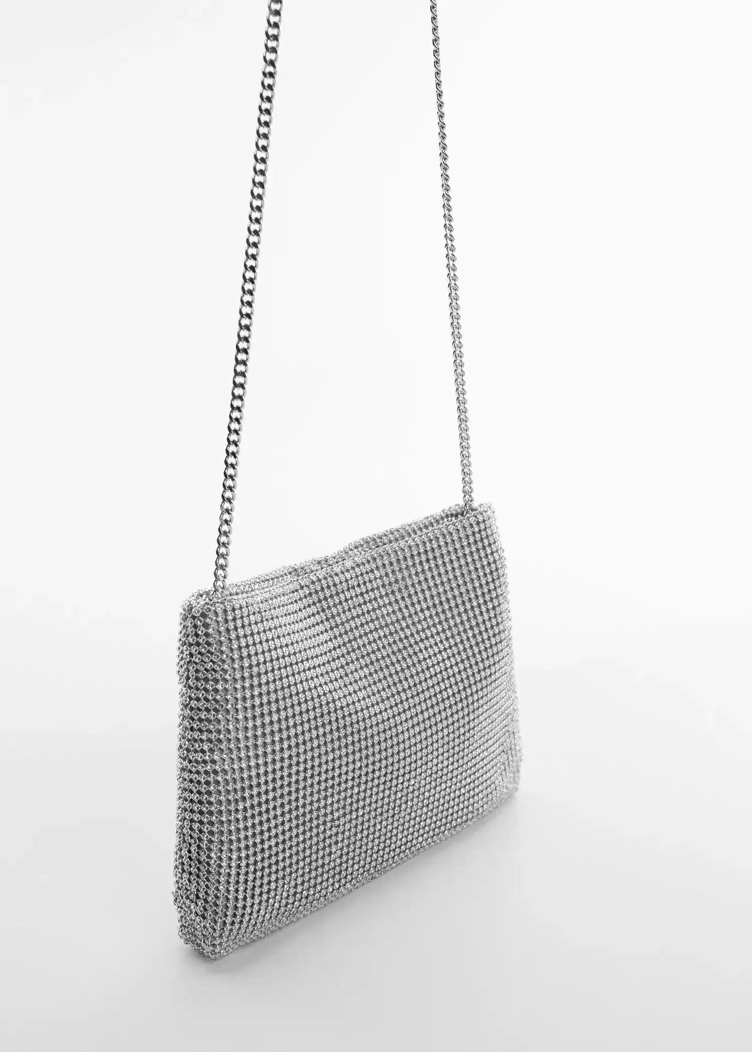 Mango Rhinestone chain bag. a close-up of a silver purse on a white surface. 