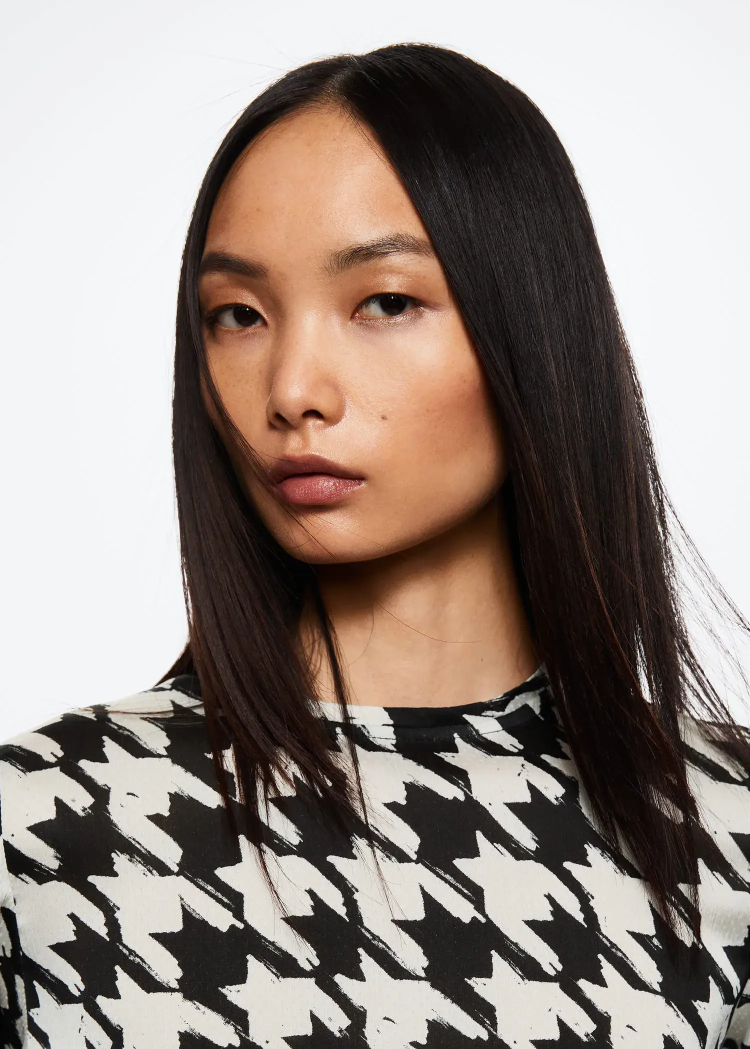 Mango Houndstooth blouse. a close up of a person with long hair. 