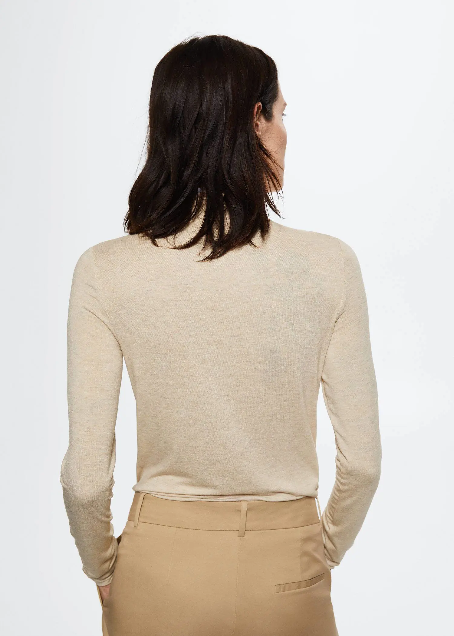 Mango Ruched detail T-shirt. a woman in a tan suit is wearing a beige shirt. 