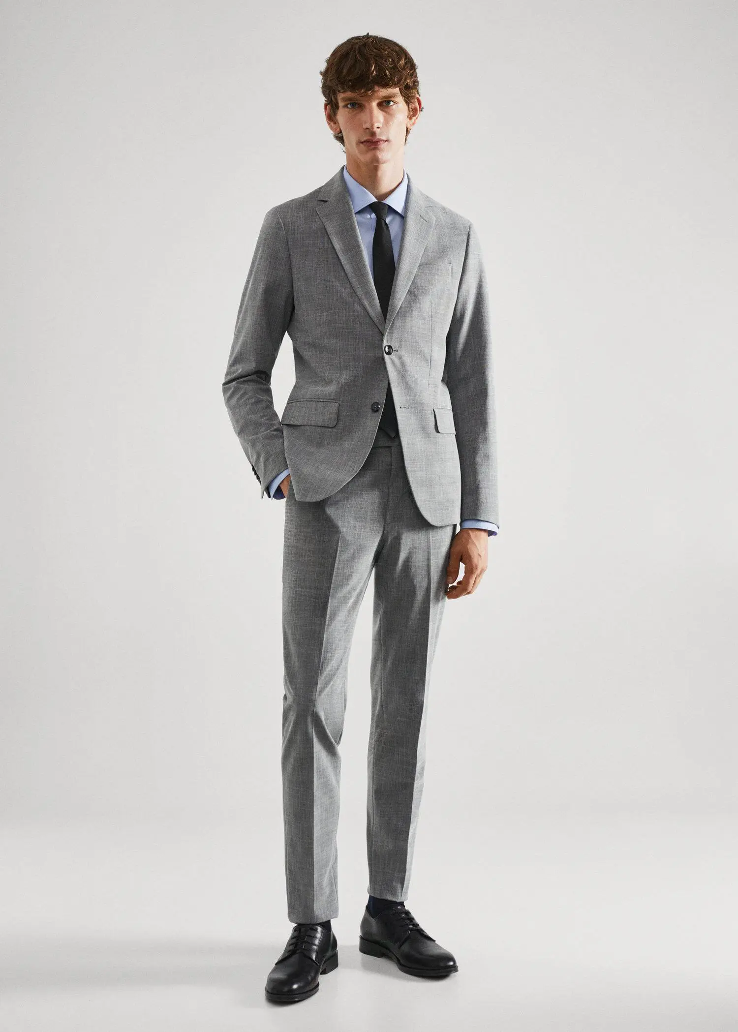Mango Stretch fabric slim-fit printed suit blazer . a man wearing a suit and tie standing in a room. 