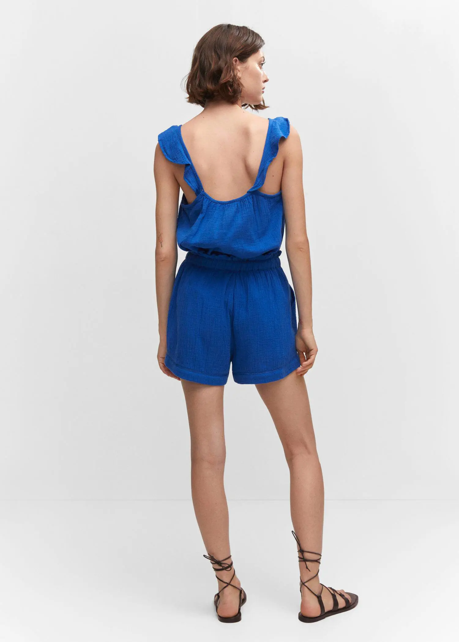 Mango Textured shorts with bow. a woman in a blue outfit is standing. 