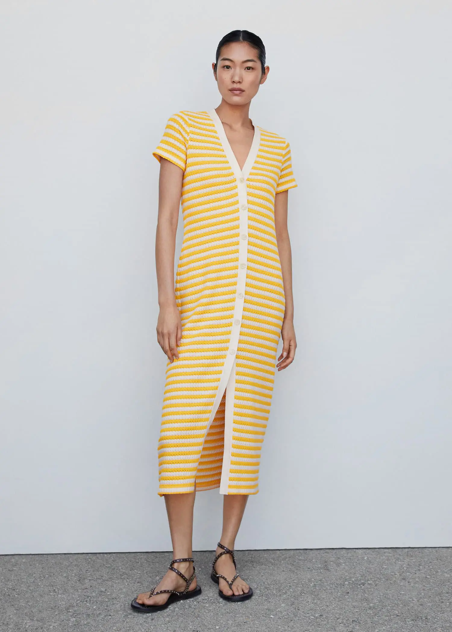 Mango Striped jersey dress. a woman wearing a yellow and white striped dress. 