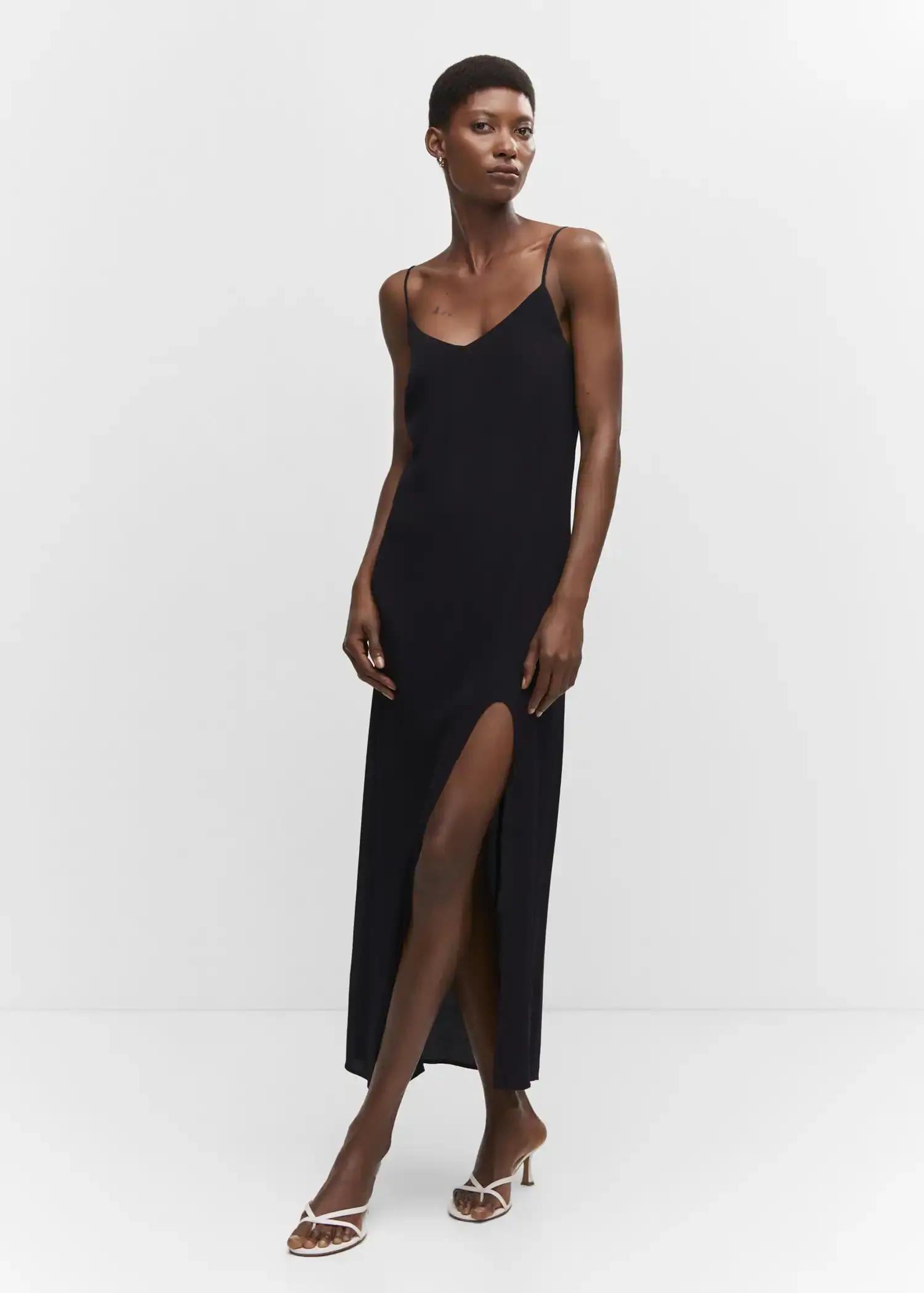 Mango Slit long dress. a woman in a black dress is posing. 