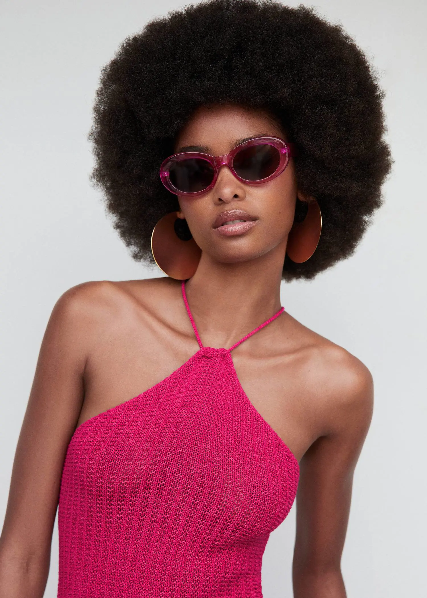 Mango Semi-transparent frame sunglasses. a woman wearing a pink top and sunglasses. 