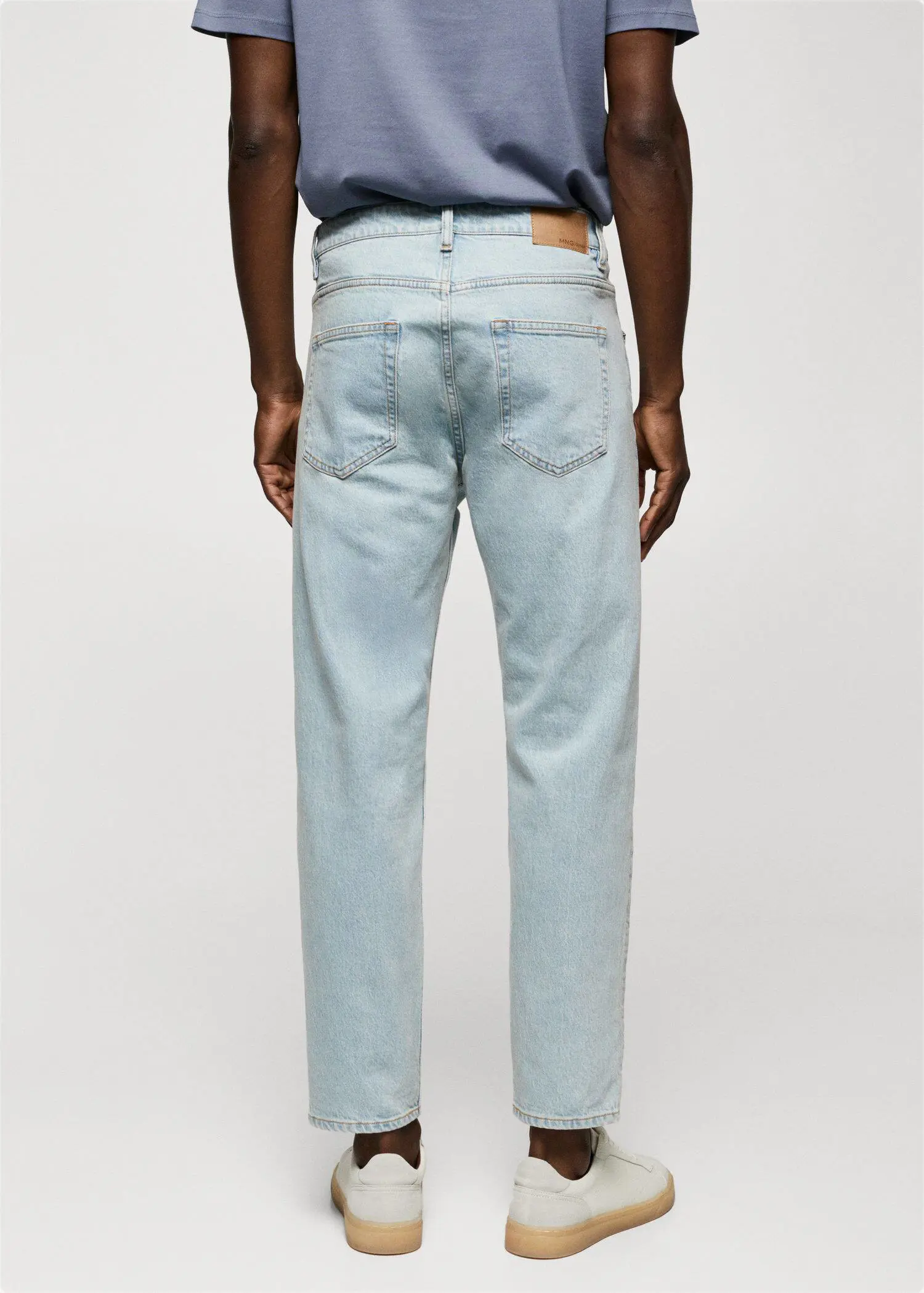 Mango Ben tapered cropped jeans. a person wearing light blue jeans and a white shirt. 