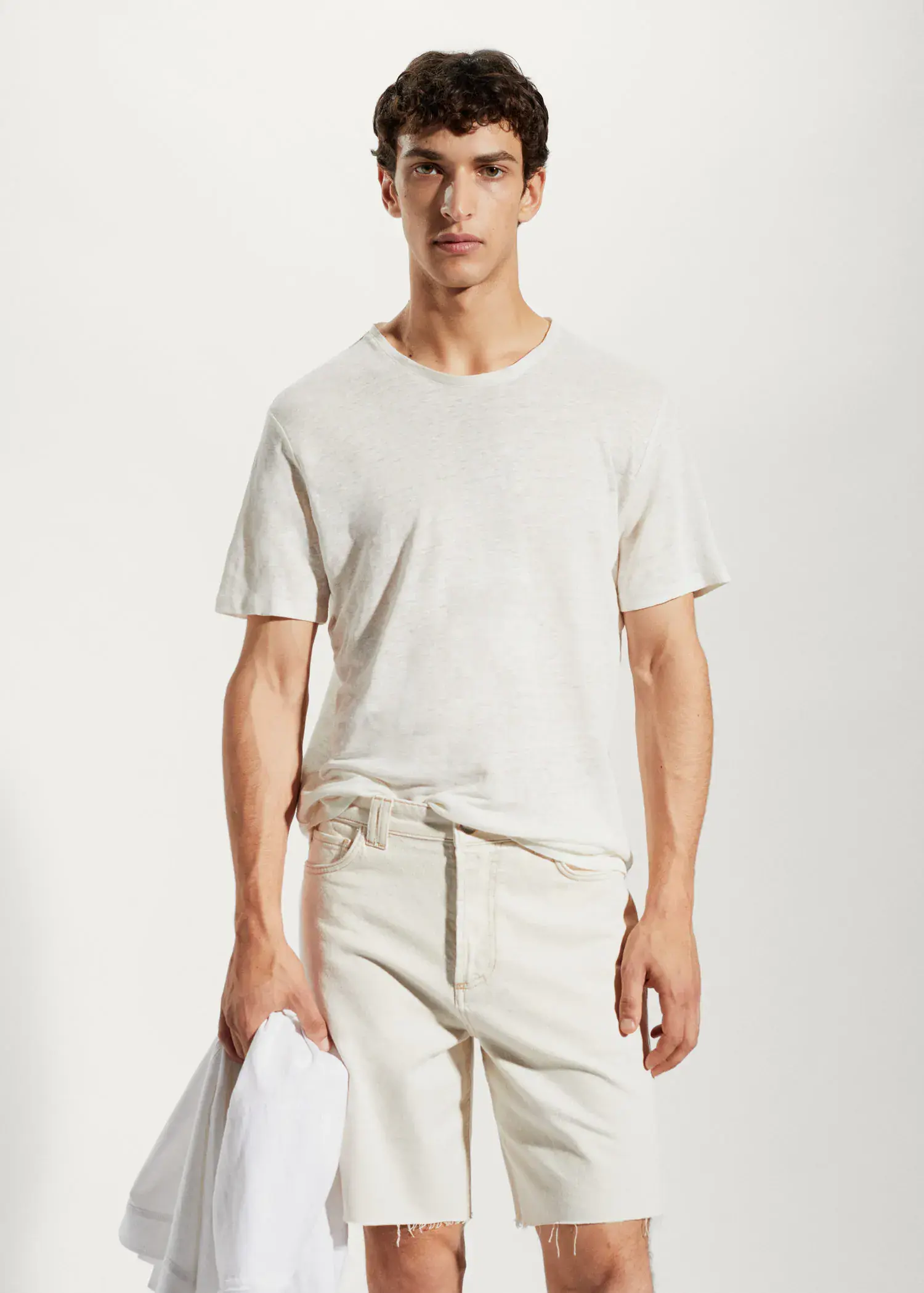 Mango 100% linen slim-fit t-shirt. a man in white shirt and shorts holding a white object. 